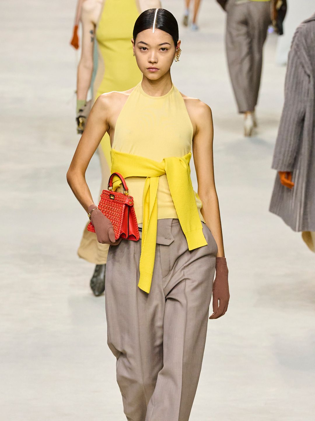 Fendi SS24 model wearing jumper tied around her mid-section 