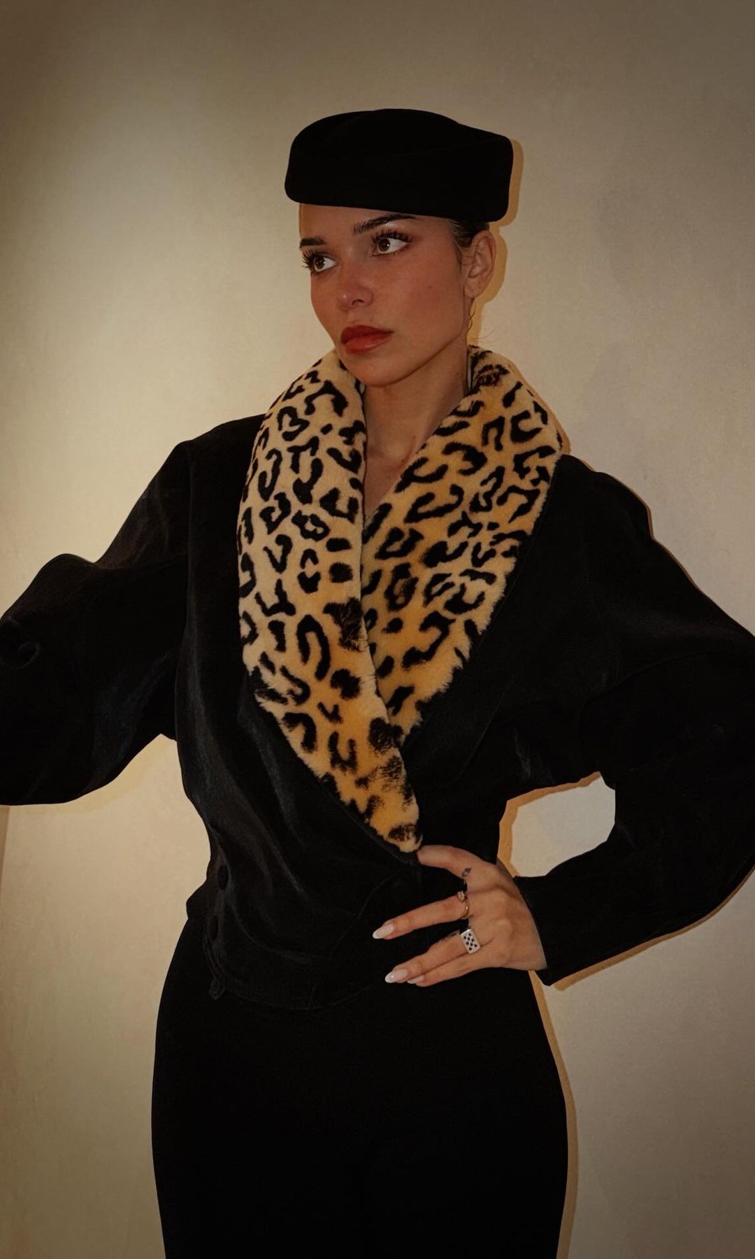 Jackie Apostel poses in a fur fringe coat and pillbox hat 