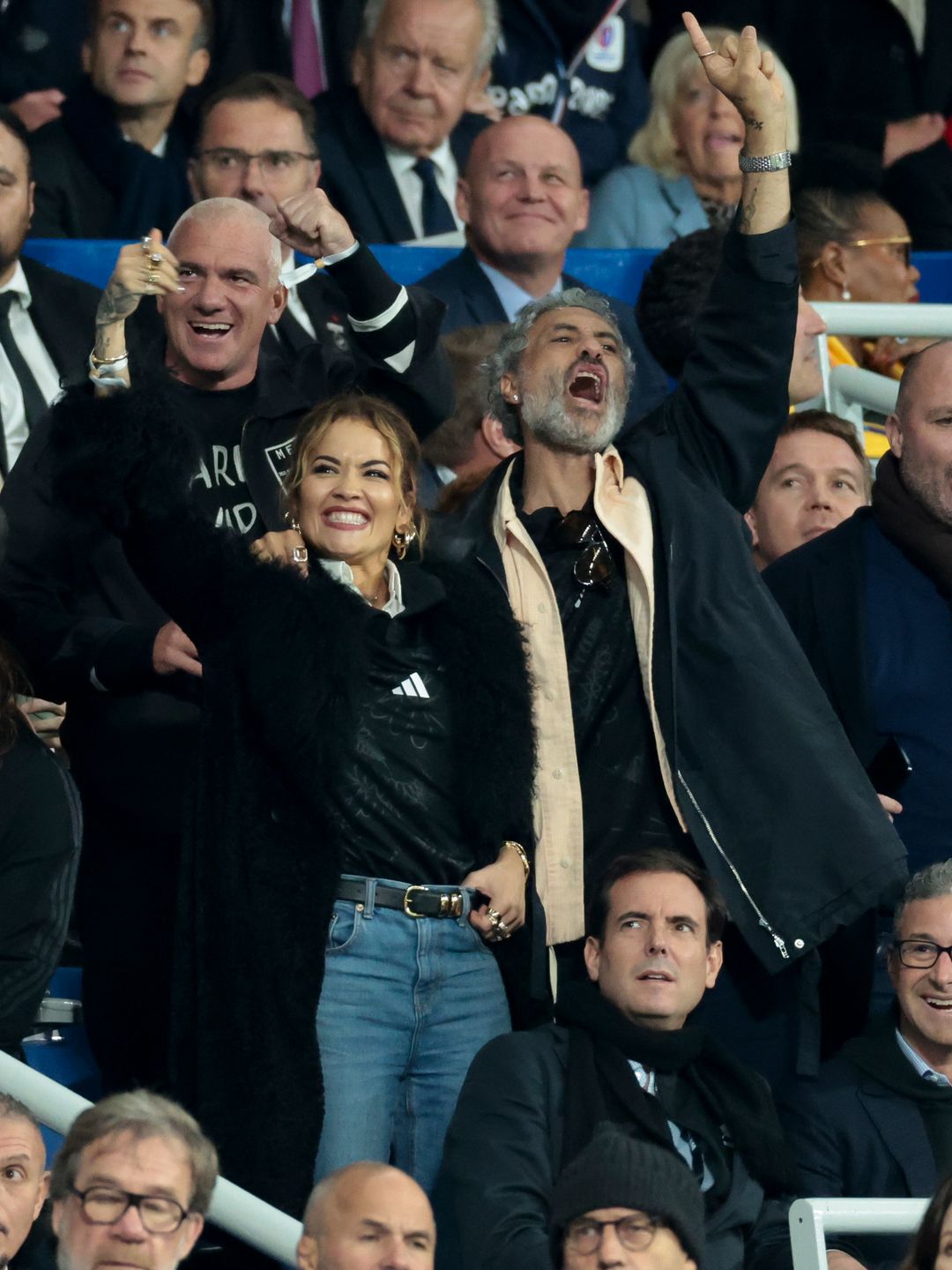 Rita Ora and Taika Waititi cheering in the crowd 