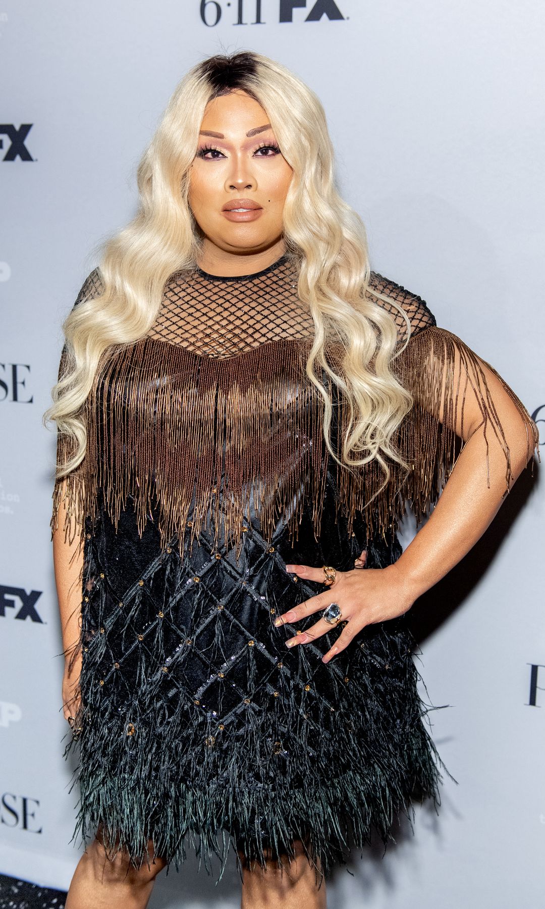 Jiggly Caliente in a brown and black dress