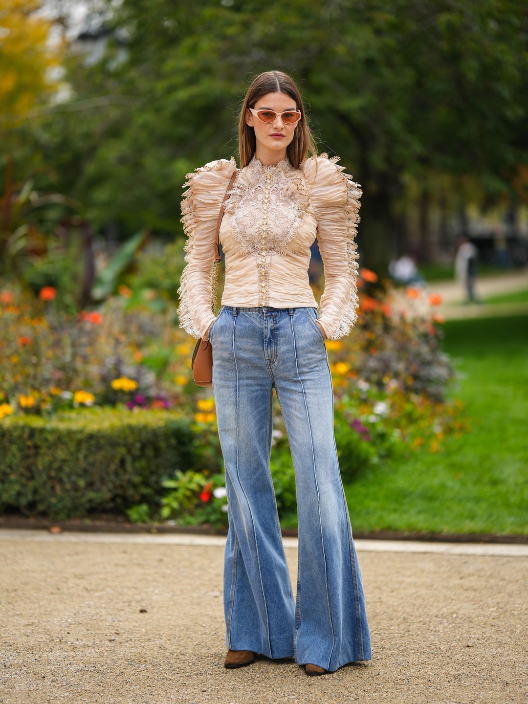 Ophelie Guillermand wearing flares with a lace-trimmed blouse 
