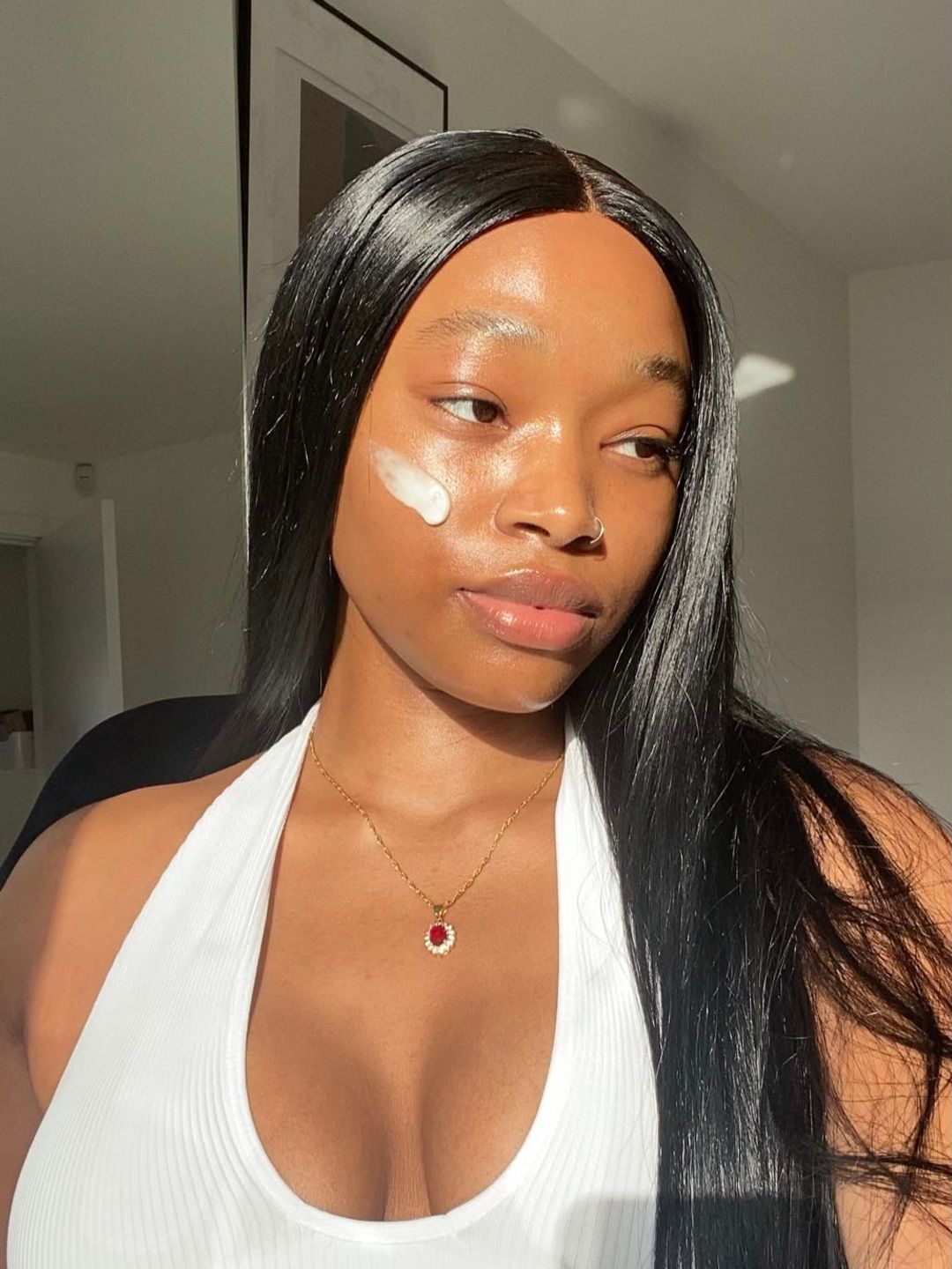 Uche Natori with skincare on her face 
