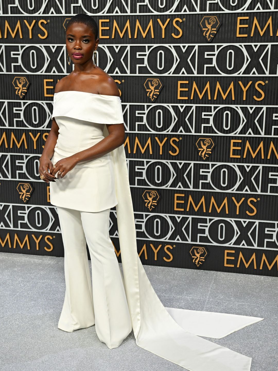 Joy Sunday wearing cream Bardot top and flared trousers at the 2024 Emmys