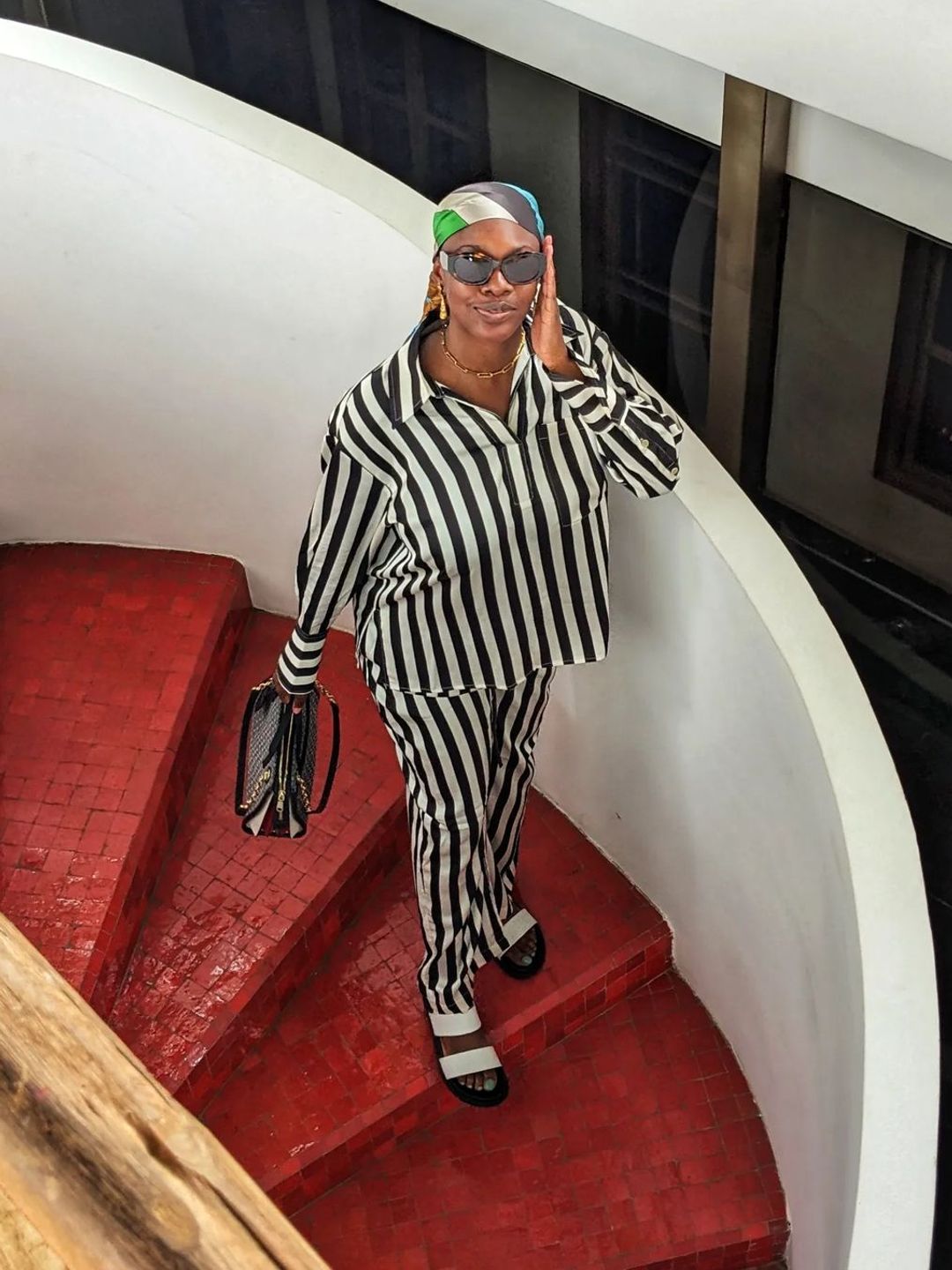 Yomi Adegoke wears a stripe twin set