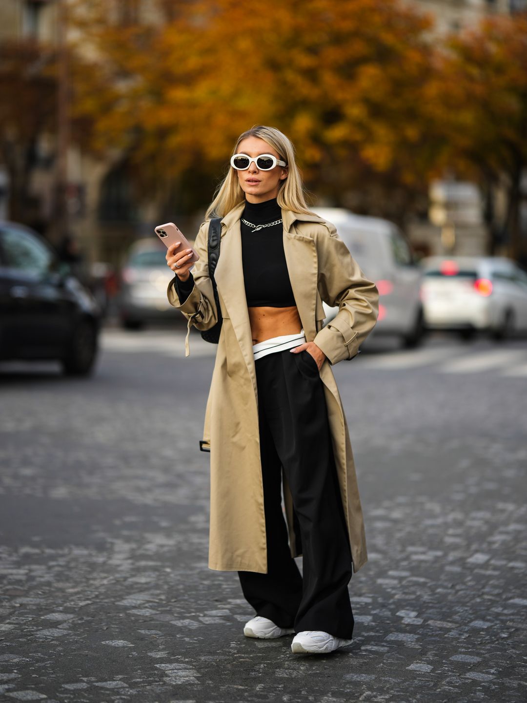 Woman wearing a trench coat with a crop top 