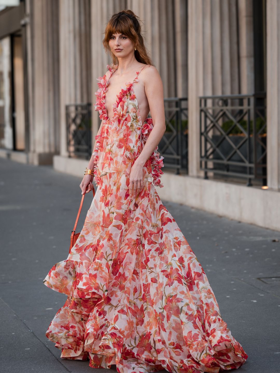 ustine Soranzo wears cream and orange flower print maxi dress, outside Zimmermann
