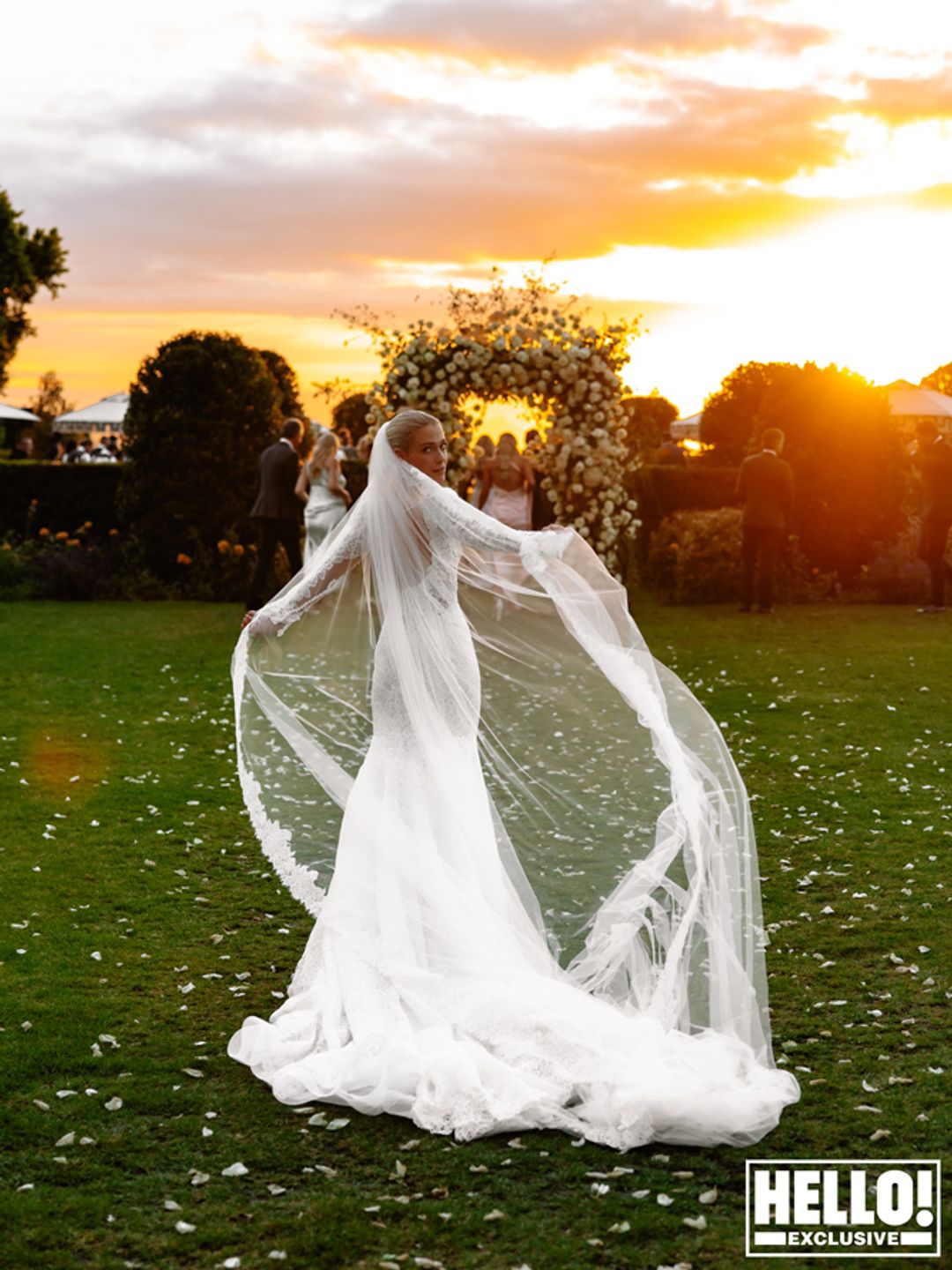 Amelia Spencer showing off her veil with the sunset behind her