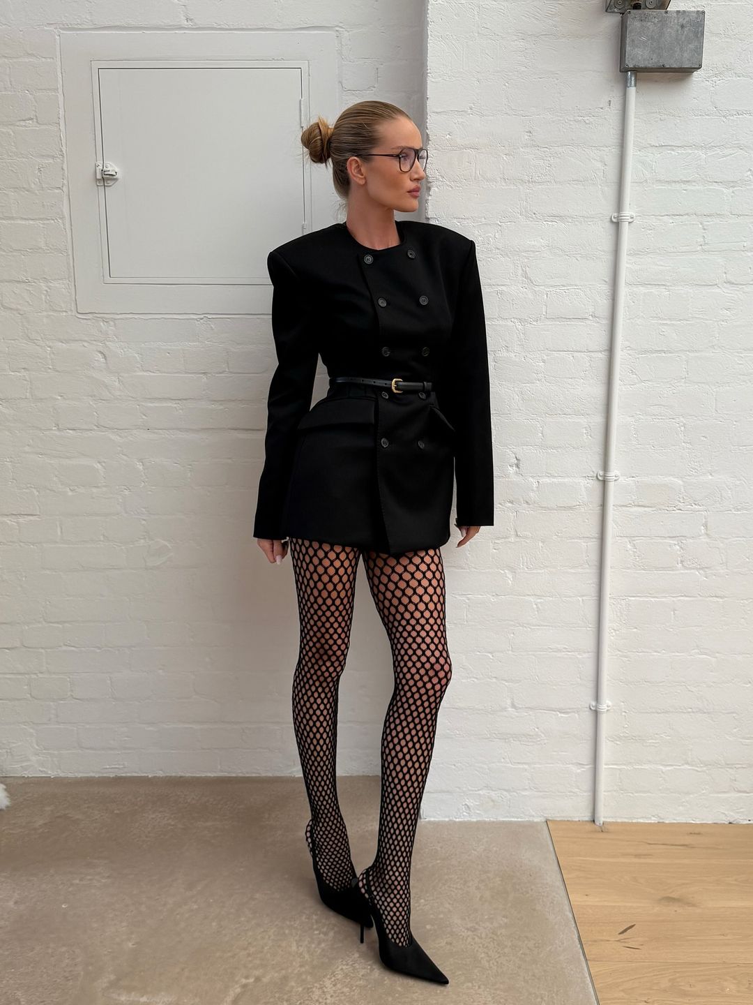 Rosie Huntington-Whiteley wears fishnet tights with heels and a mini dress