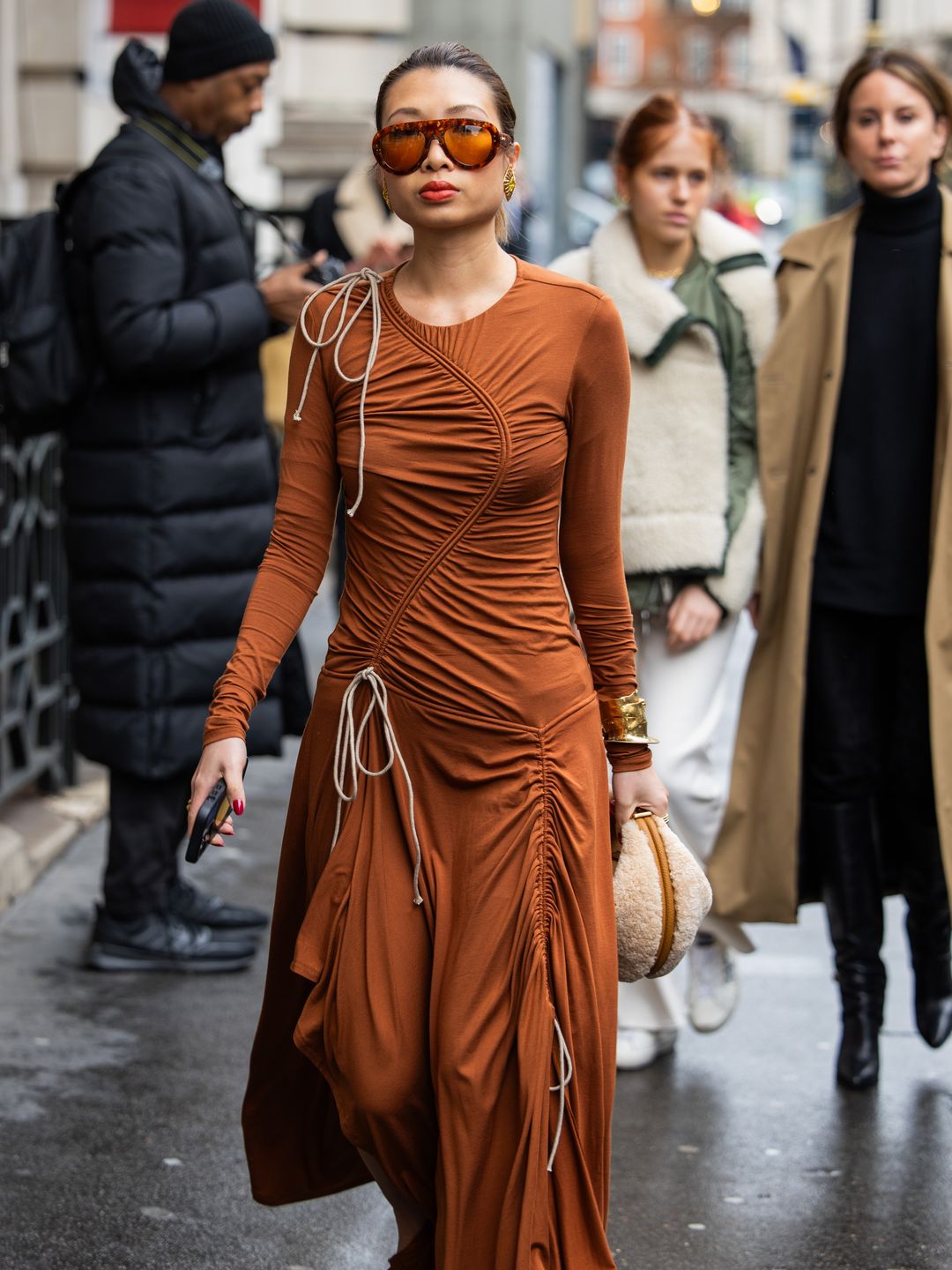  Rosana Lai wears brown dress, teddy bag outside Emilia Wickstead during London Fashion Week 