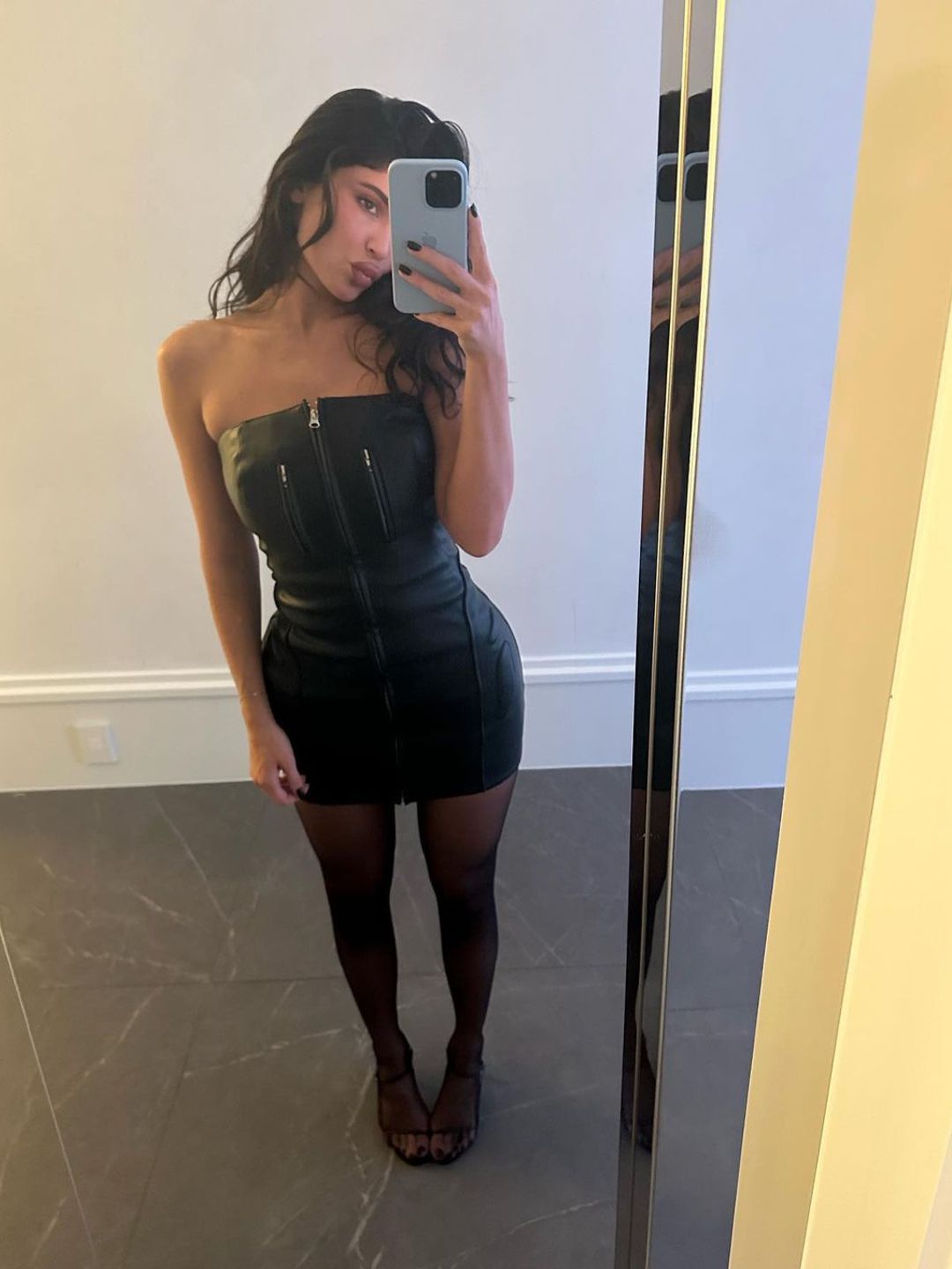 Kylie Jenner rocking a short black manicure and a black mini dress on Instagram 
