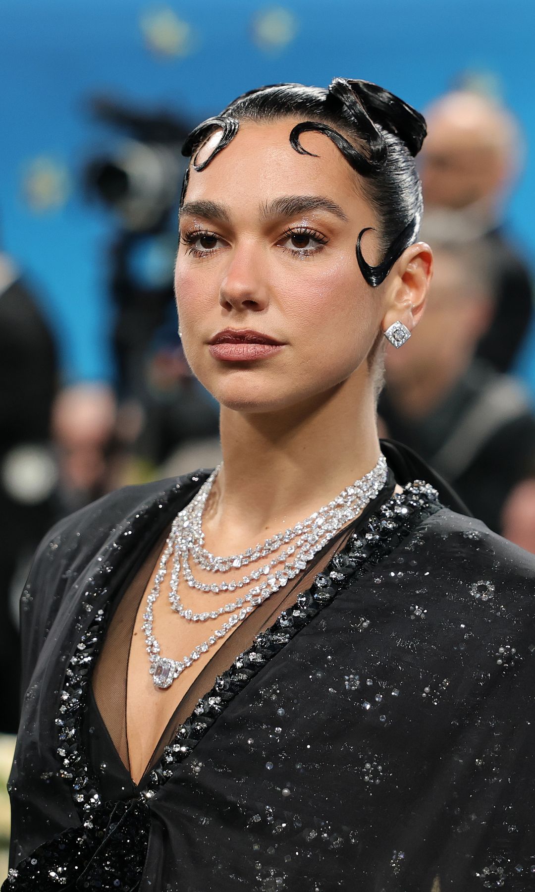 Dua Lipa in a black and bejewelled dress