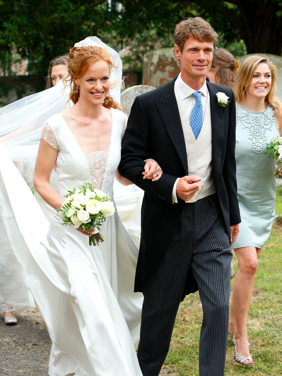 Alicia Fox-Pitt in a wedding gown walking with William Fox-Pitt