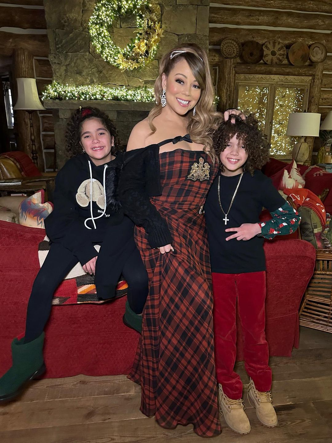 Mariah Carey standing with twins Morrocan and Monroe. 