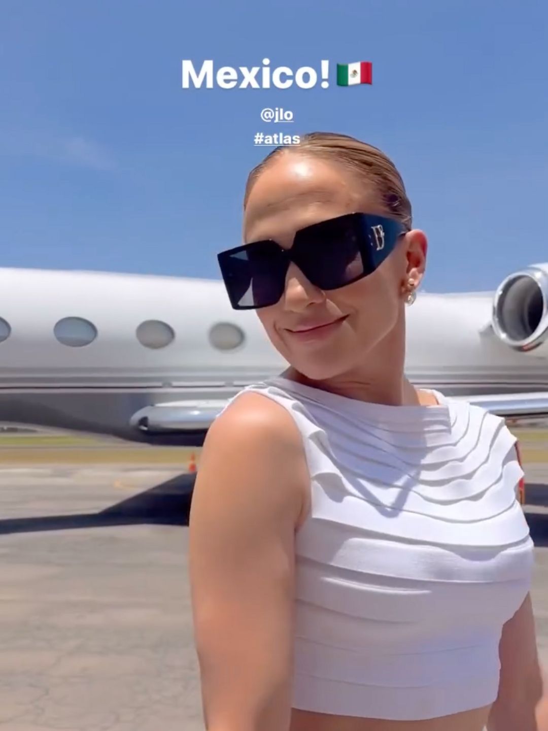 Jennifer Lopez poses at the airport in a pair of bold sunglasses 