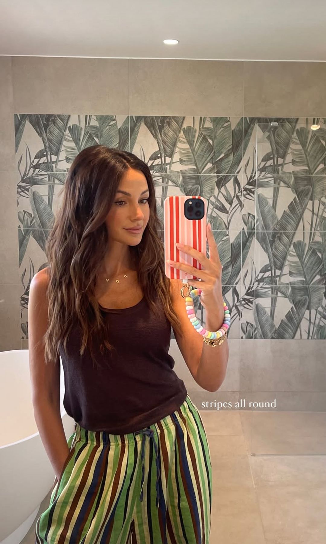 Michelle Keegan taking a selfie in striped trousers and her hair in mermaid waves