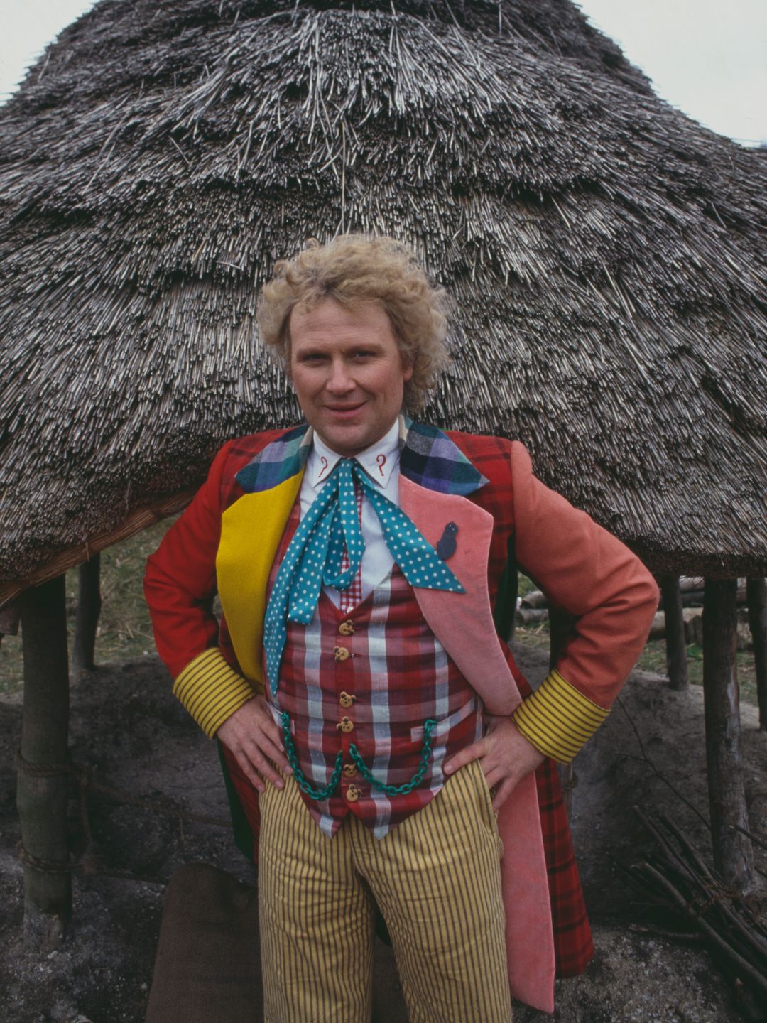 Colin Baker in multicoloured outfit in character as The Doctor