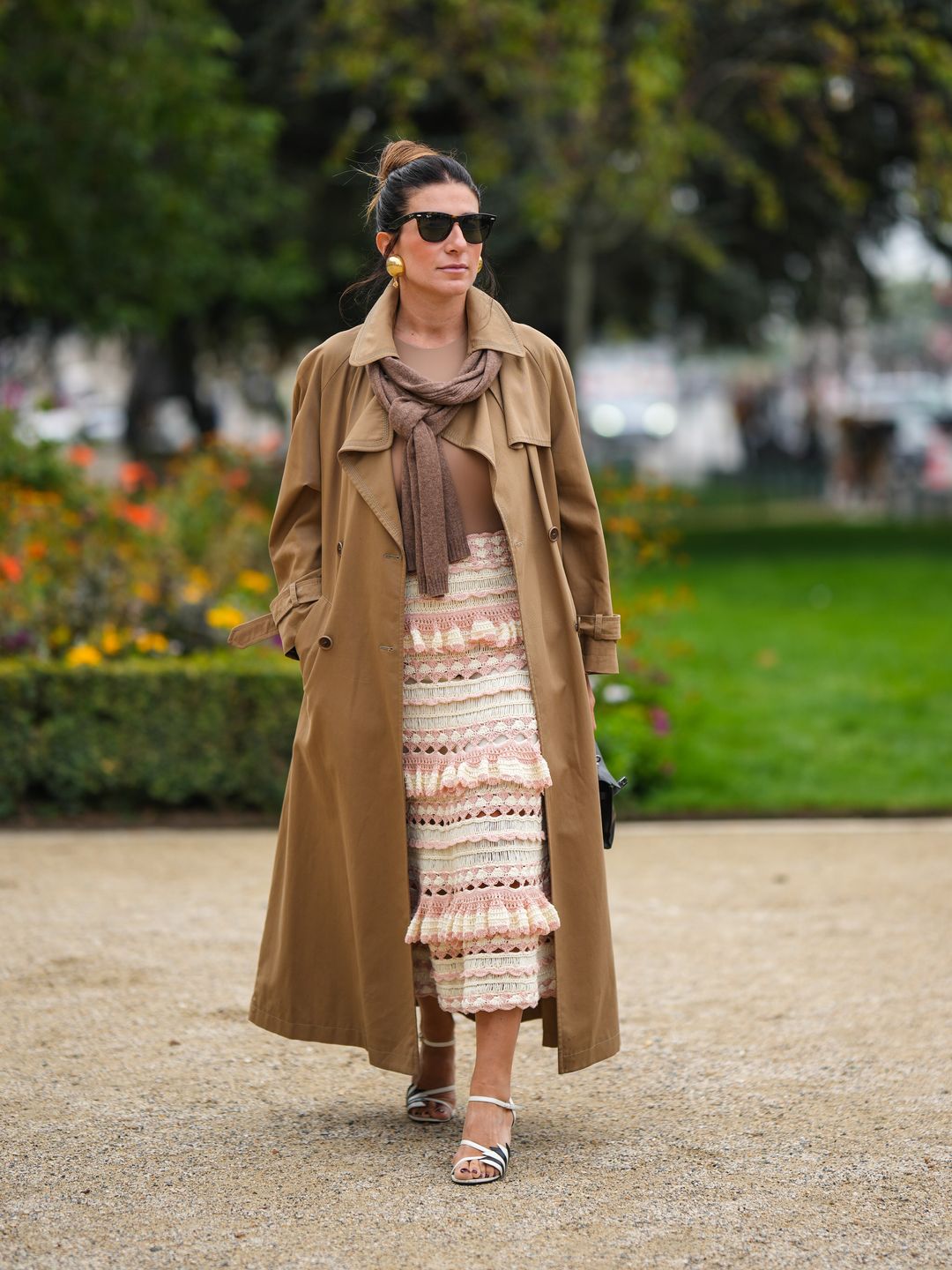 Woman wearing trench coat with crochet skirt 