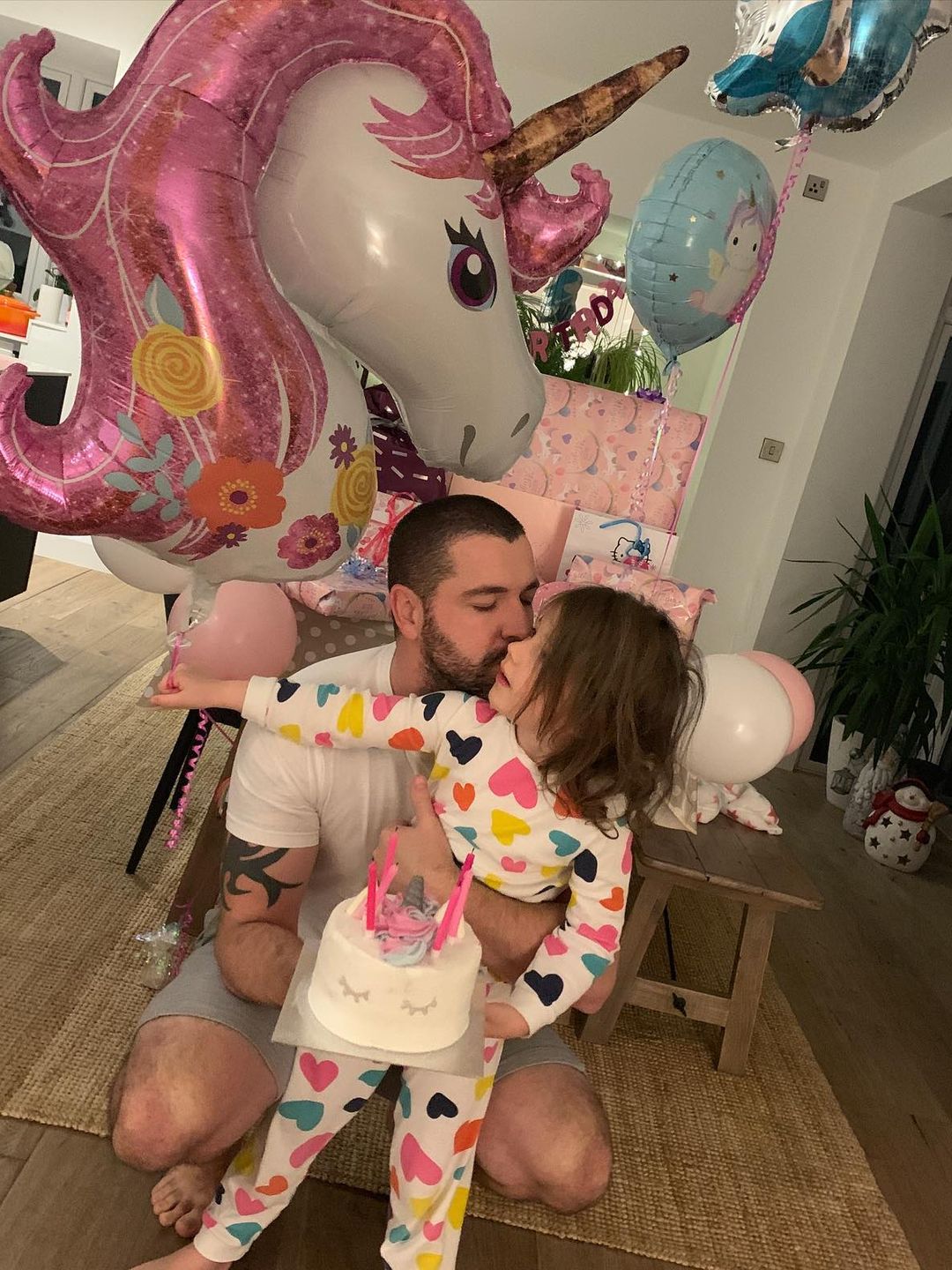 father posing with daughter in kitchen