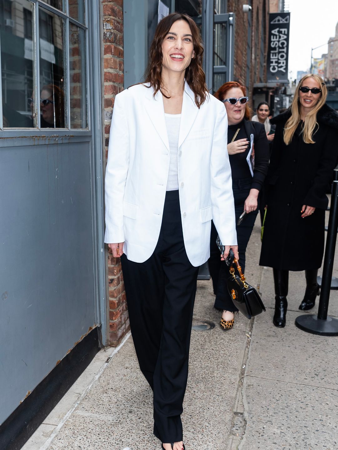 Alexa Chung kept things casual for the Proenza Schouler fashion show in a white blazer and black trouser ensemble.