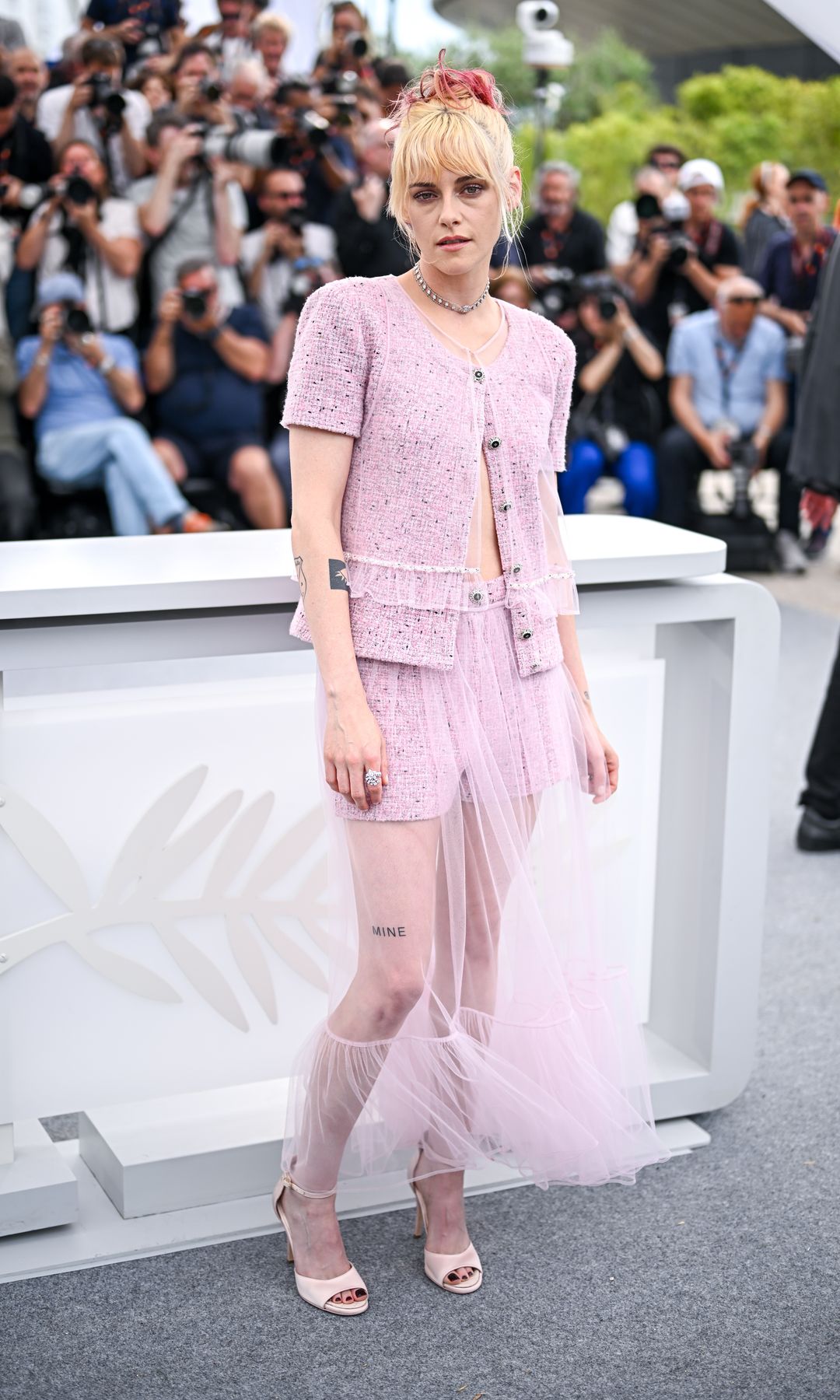 Kristen Stewart poses during "The Chronology of Water" photocall at the 78th annual Cannes Film Festival at Palais des Festivals on May 16, 2025 in Cannes, France in a pink Chanel outift and pink shoes