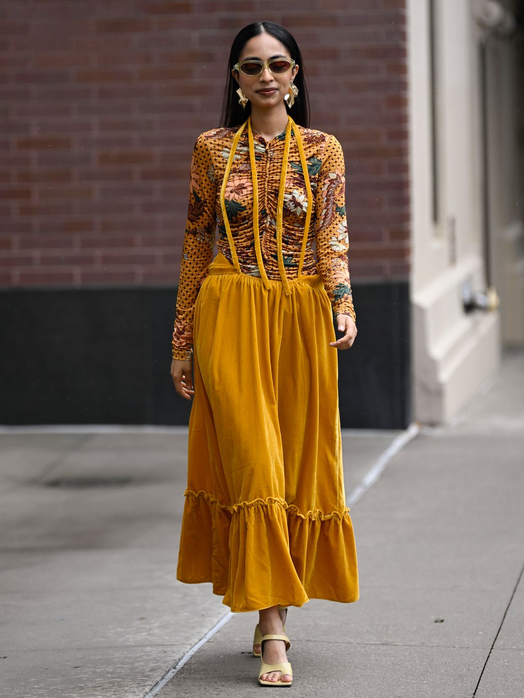 Malvika Sheth wearing a long-sleeved top with mustard skirt 