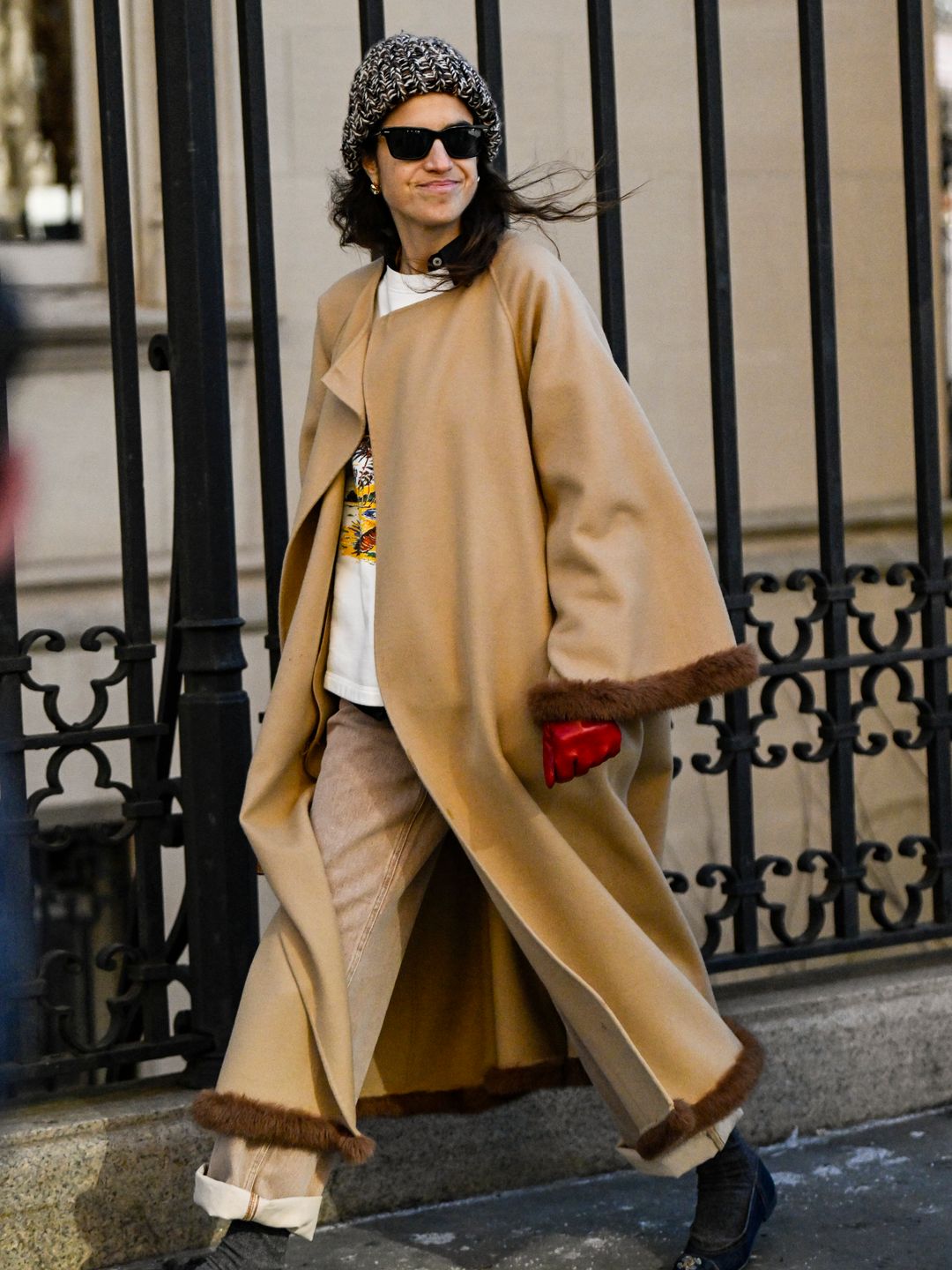 Leandra Medine is seen wearing a tan faux fur trim coat outside the Bevza show 