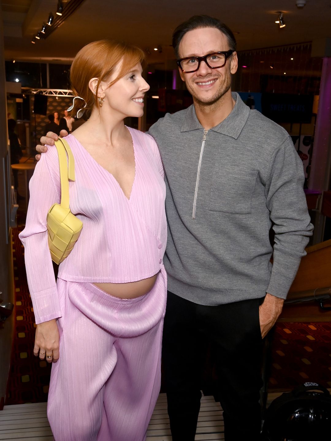 Stacey Dooley in pink stood with Kevin Clifton in a grey jumper and trousers