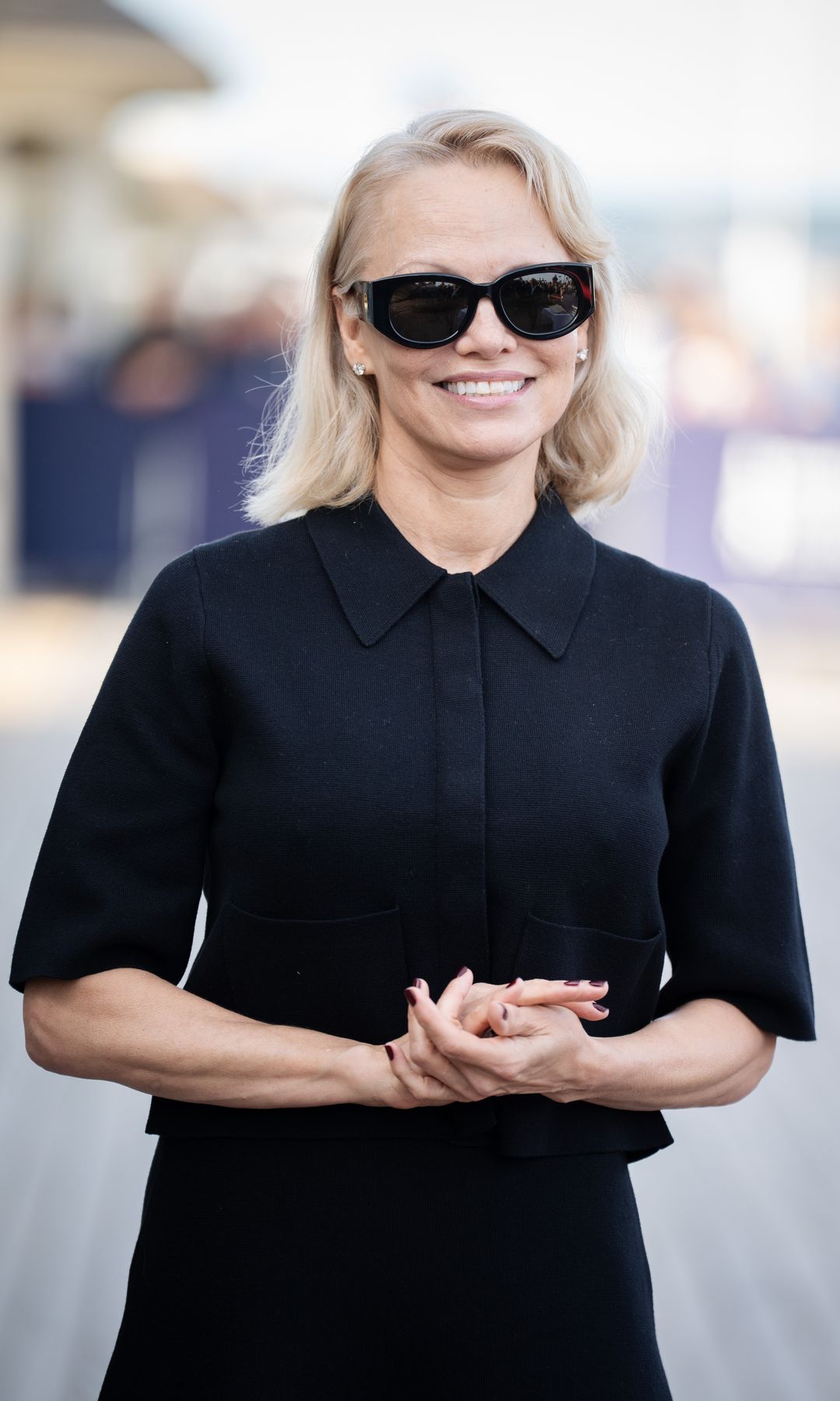 Pamela Anderson shows off her manicure at the Promenade des Planches during the 51st Deauville American Film Festival