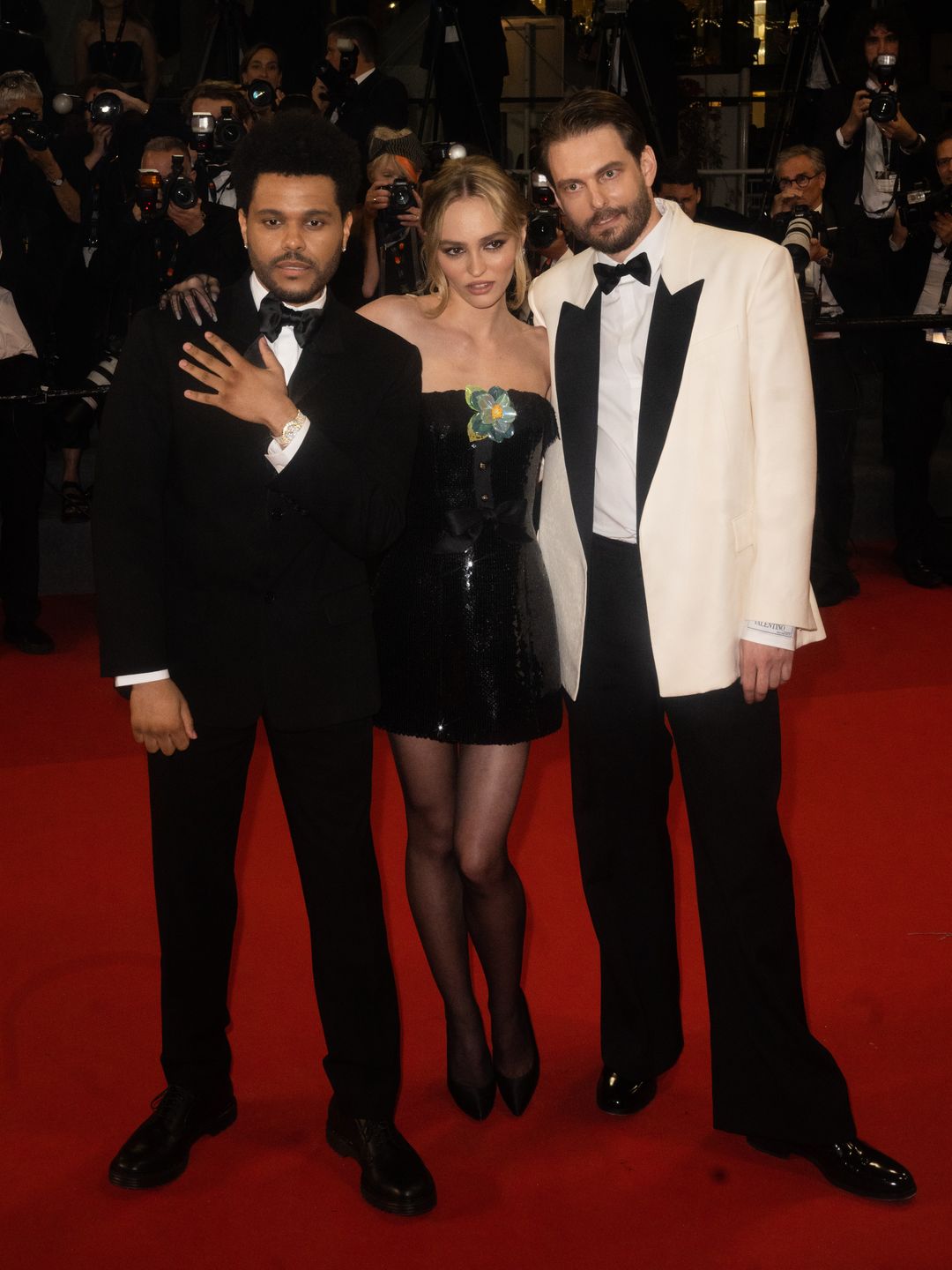 Lily-Rose Depp, Sam Levinson and The Weeknd on the red carpet 