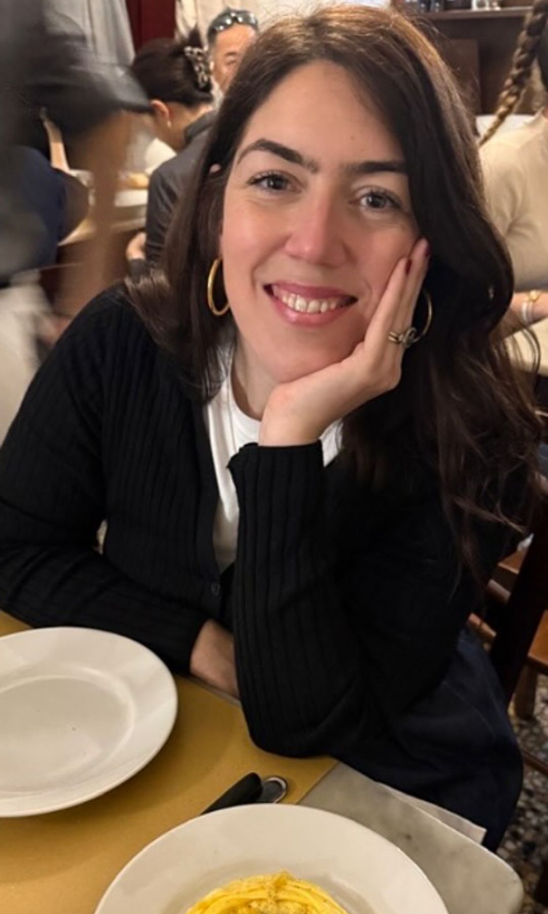 Amber Guinness sitting at a restaurant table