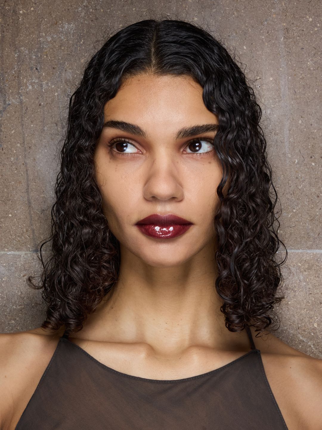 A model poses backstage in full glam at the Peter Do SS25 show