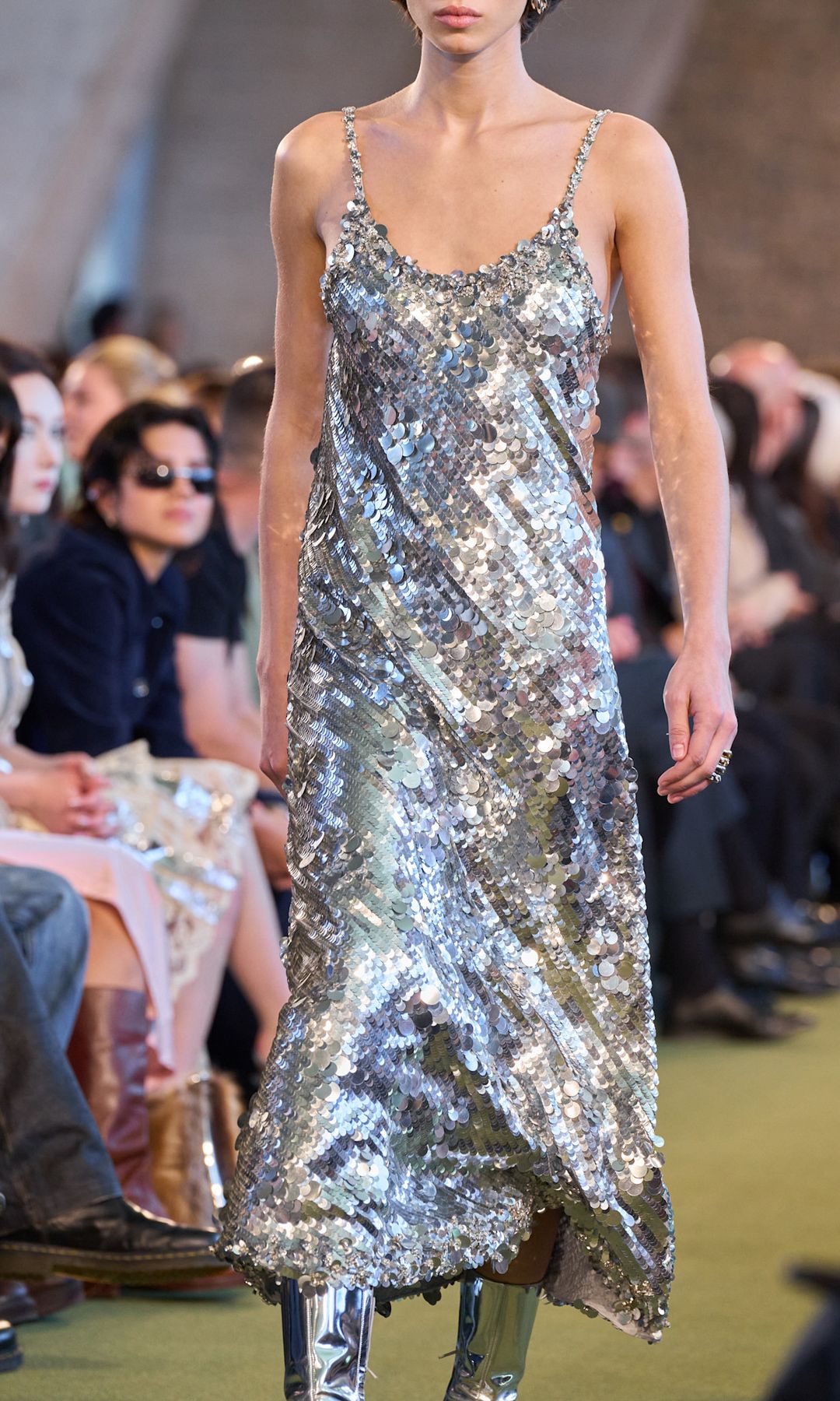 A model walks the Rabanne AW25 runway in a dazzling silver strappy dress