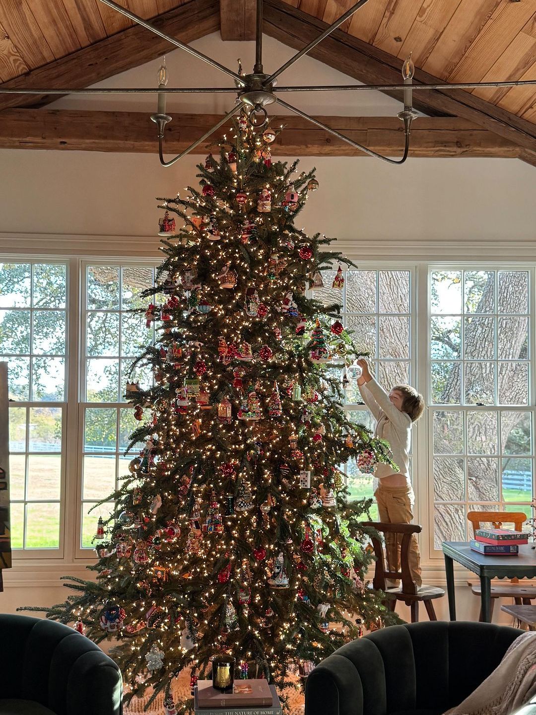 Joanna and Chip Gaines' son Crew decorates the family Christmas tree, shared on Instagram