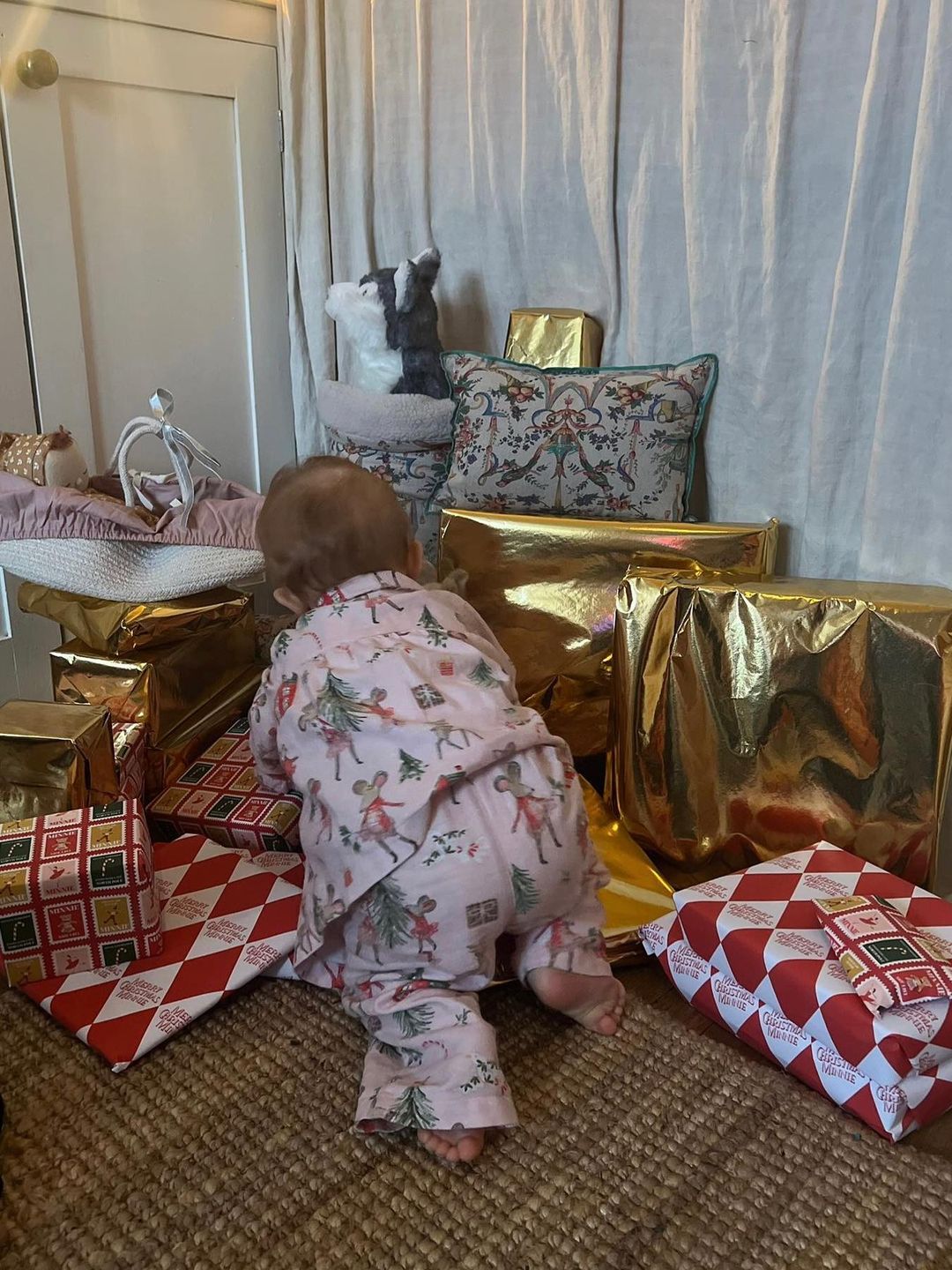 baby girl crawling in presents 