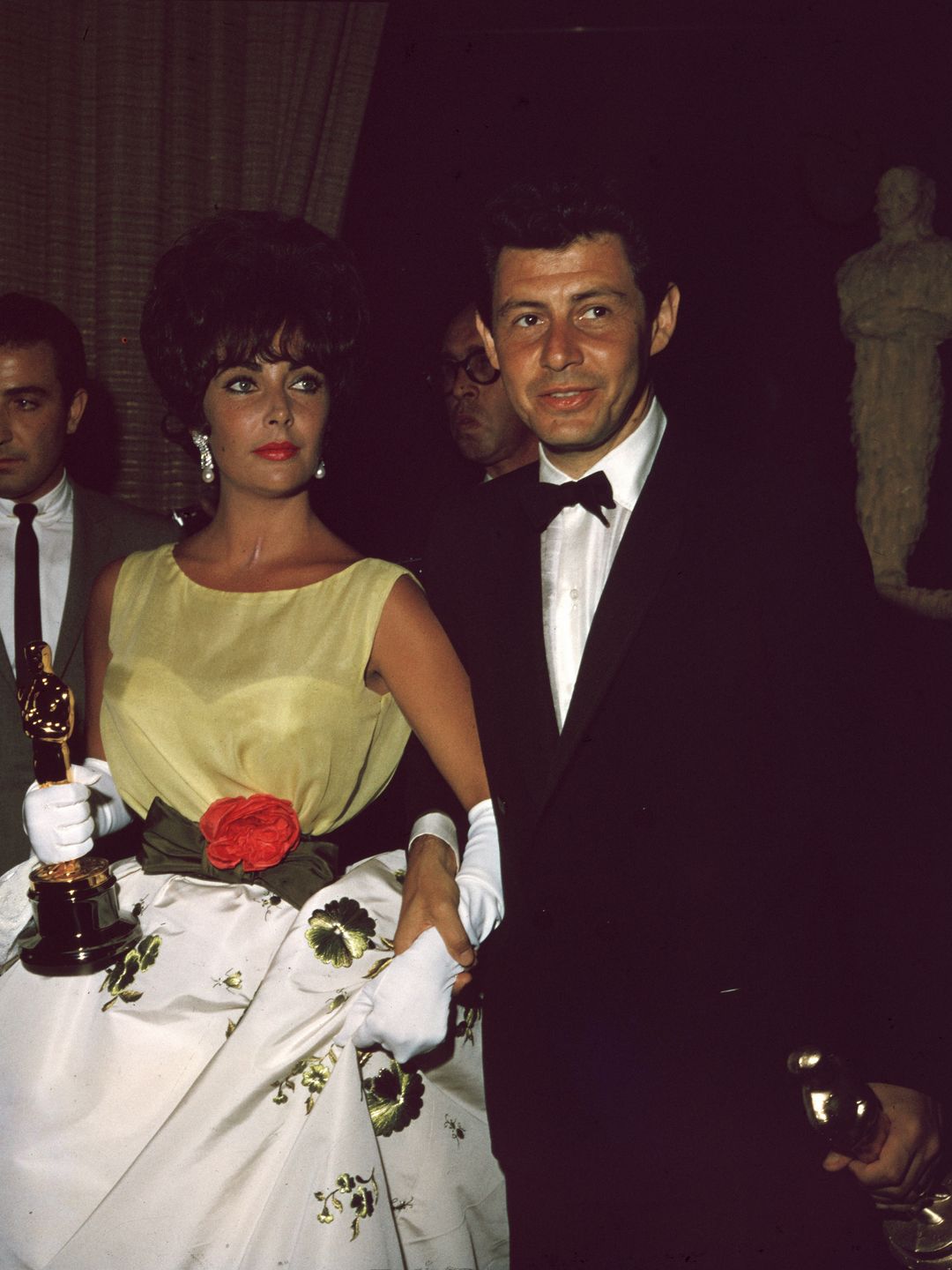 Elizabeth Taylor, holding the Oscar she won for best actress in director Daniel Mann's film, 'Butterfield 8,' with husband, American singer/actor Eddie Fisher, at the Academy Awards in 1961