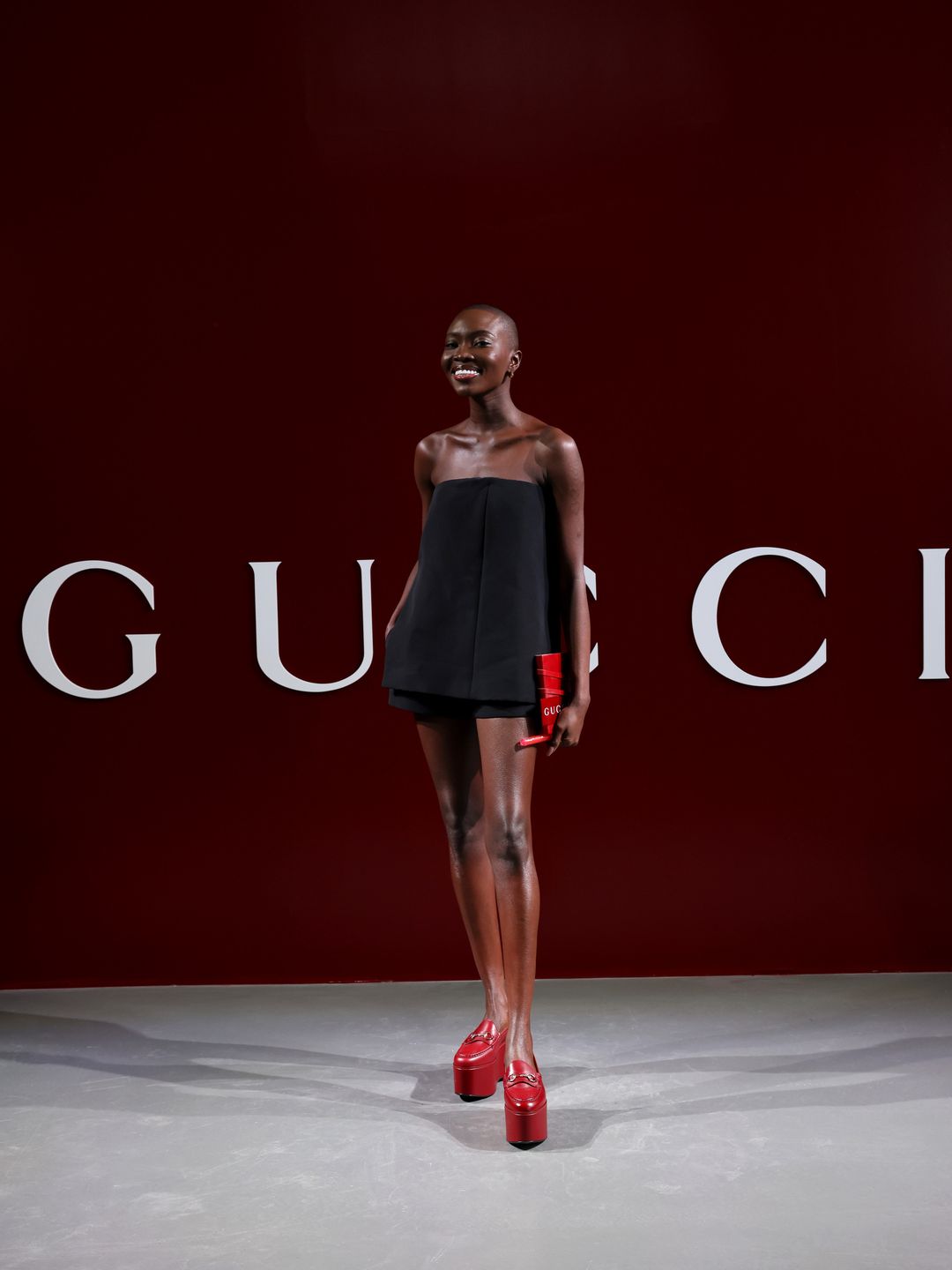Amina Sek donned a LBD and red platform heels to attend the Gucci show.