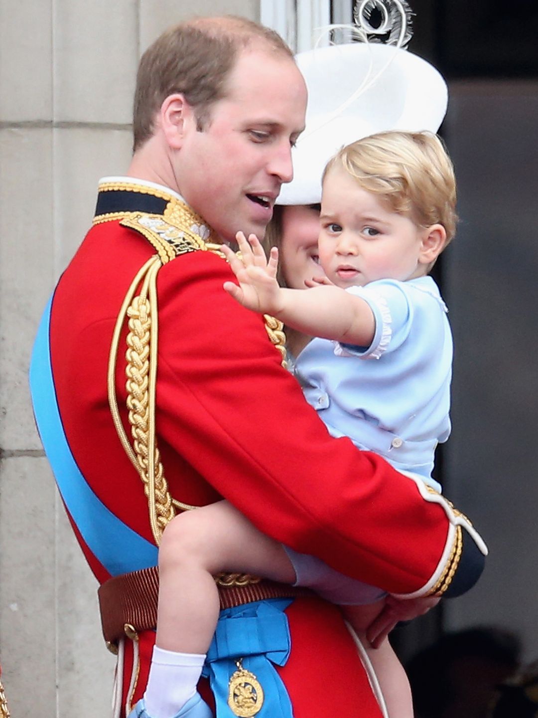 Prince William carrying a baby Prince George