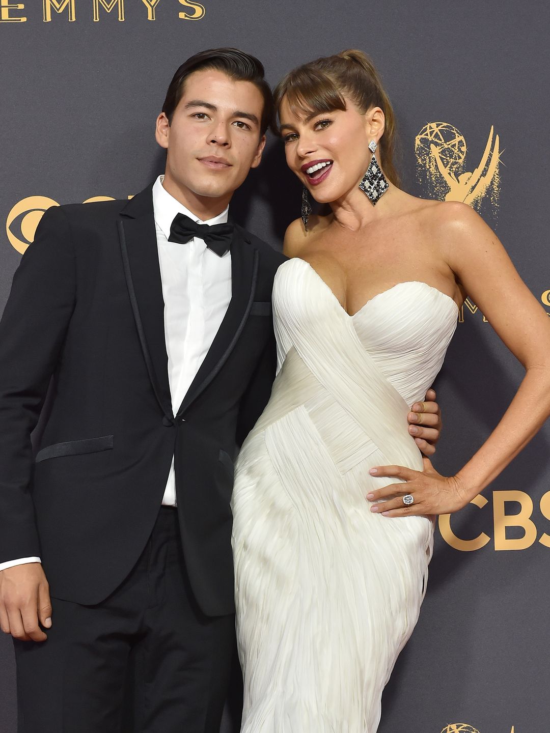 mother and son posing on red carpet