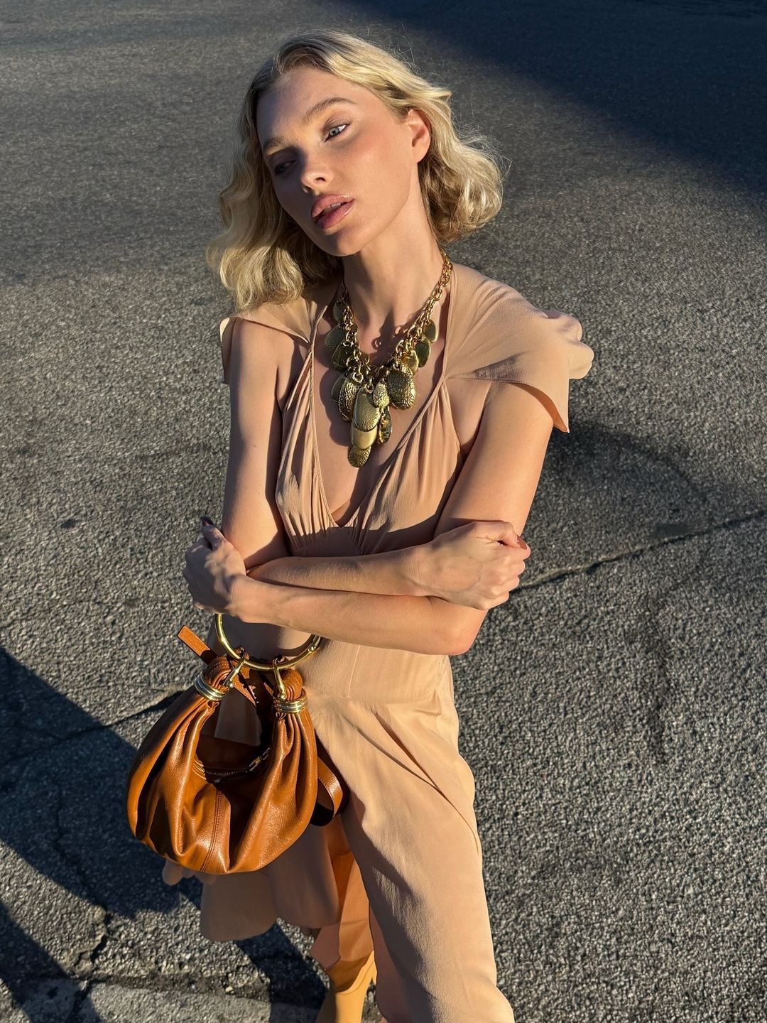 Elsa's hosk poses for a photo wearing a £890 Chloé necklace