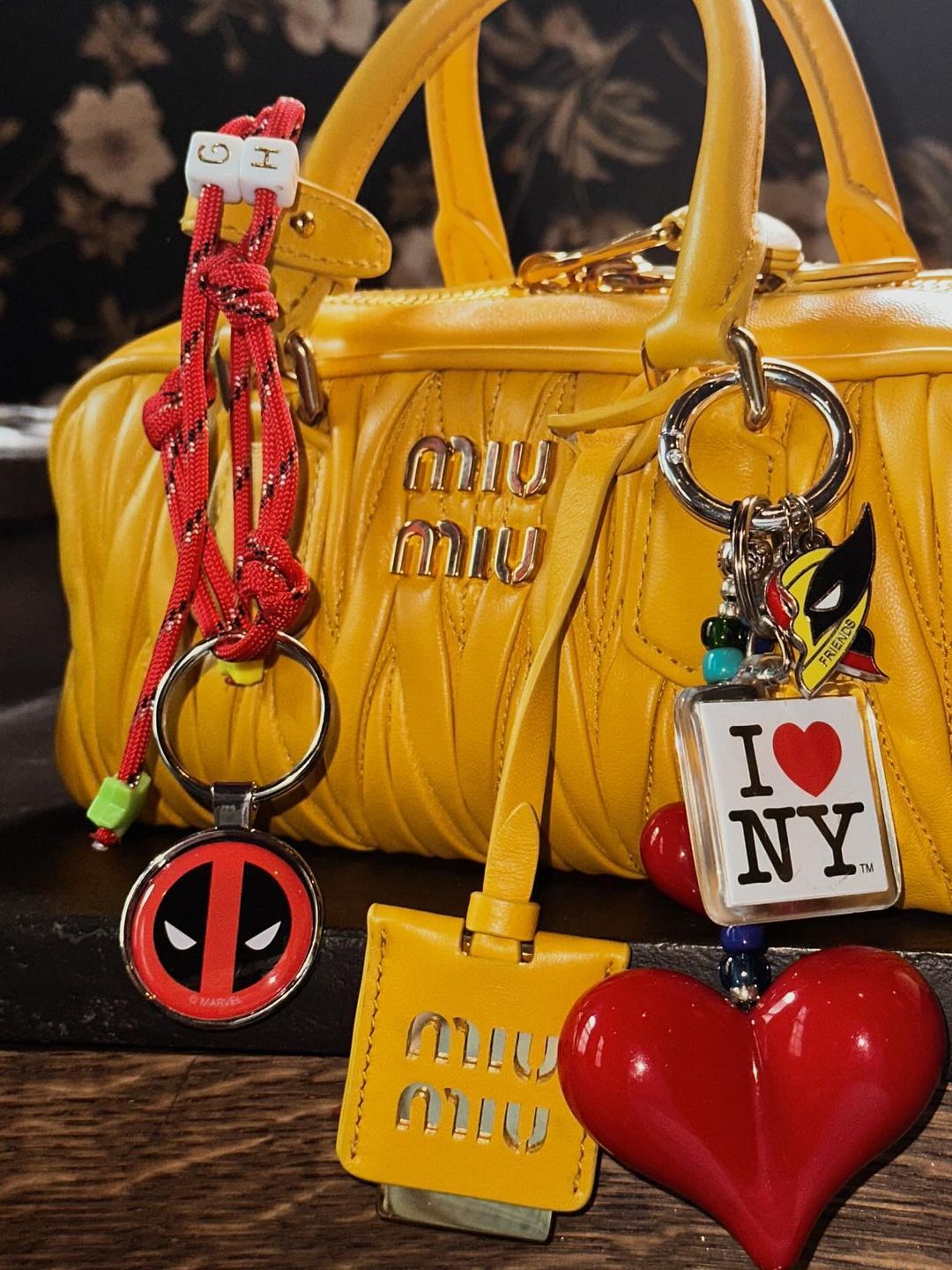 A close up Gigi Hadid's charm adorned Miu Miu bag