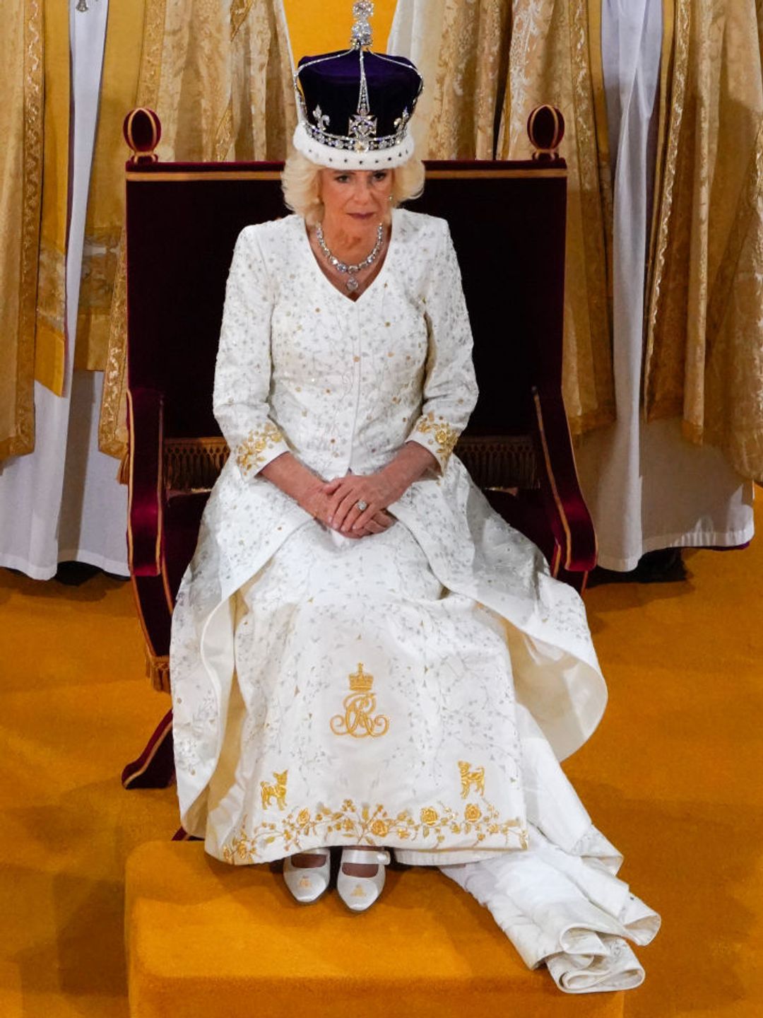 Queen Camilla's dress had been embroidered with two terriers in golden thread 