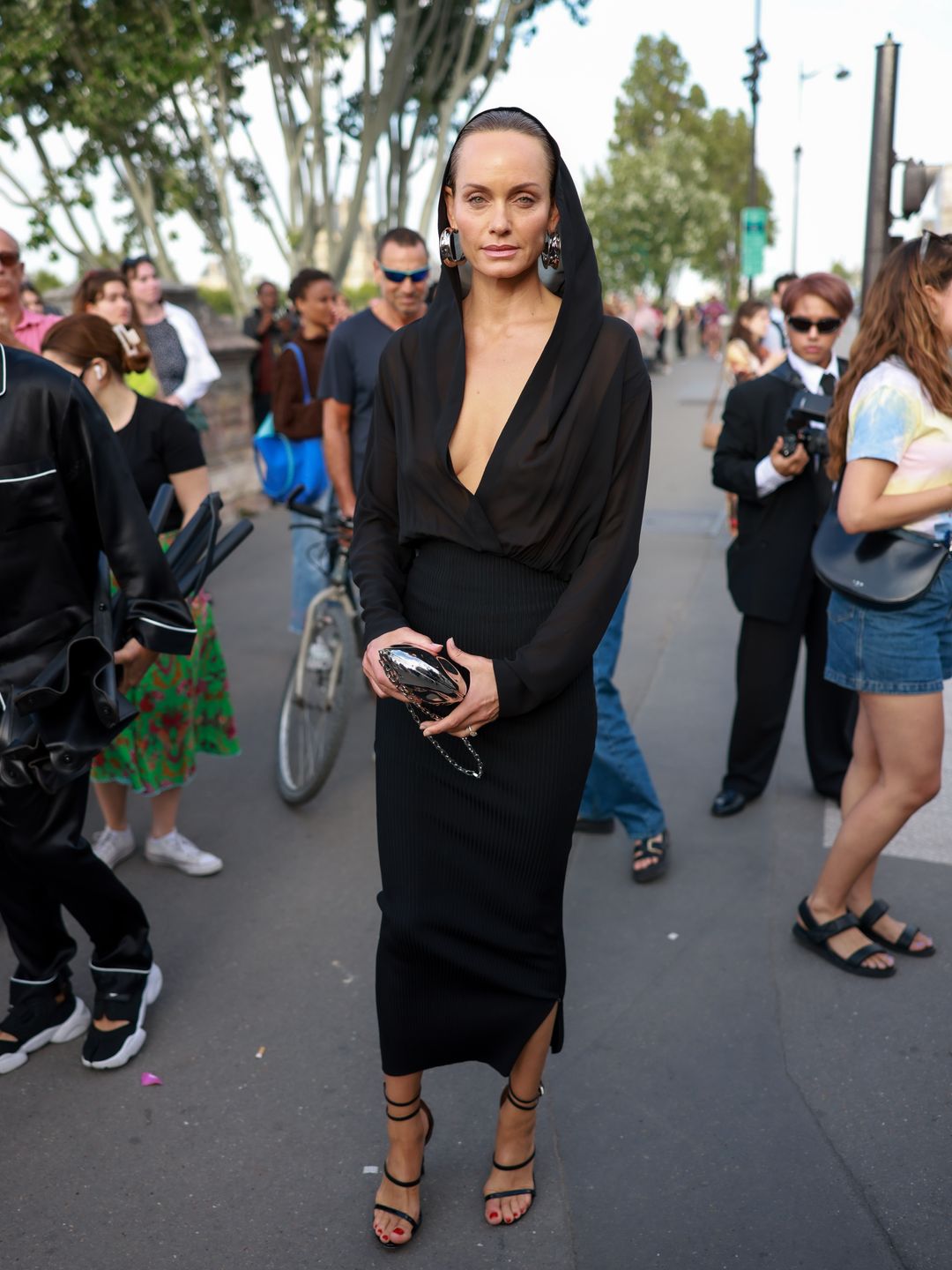Amber Valletta wore a semi-sheer hooded dress with chunky hoops earrings.