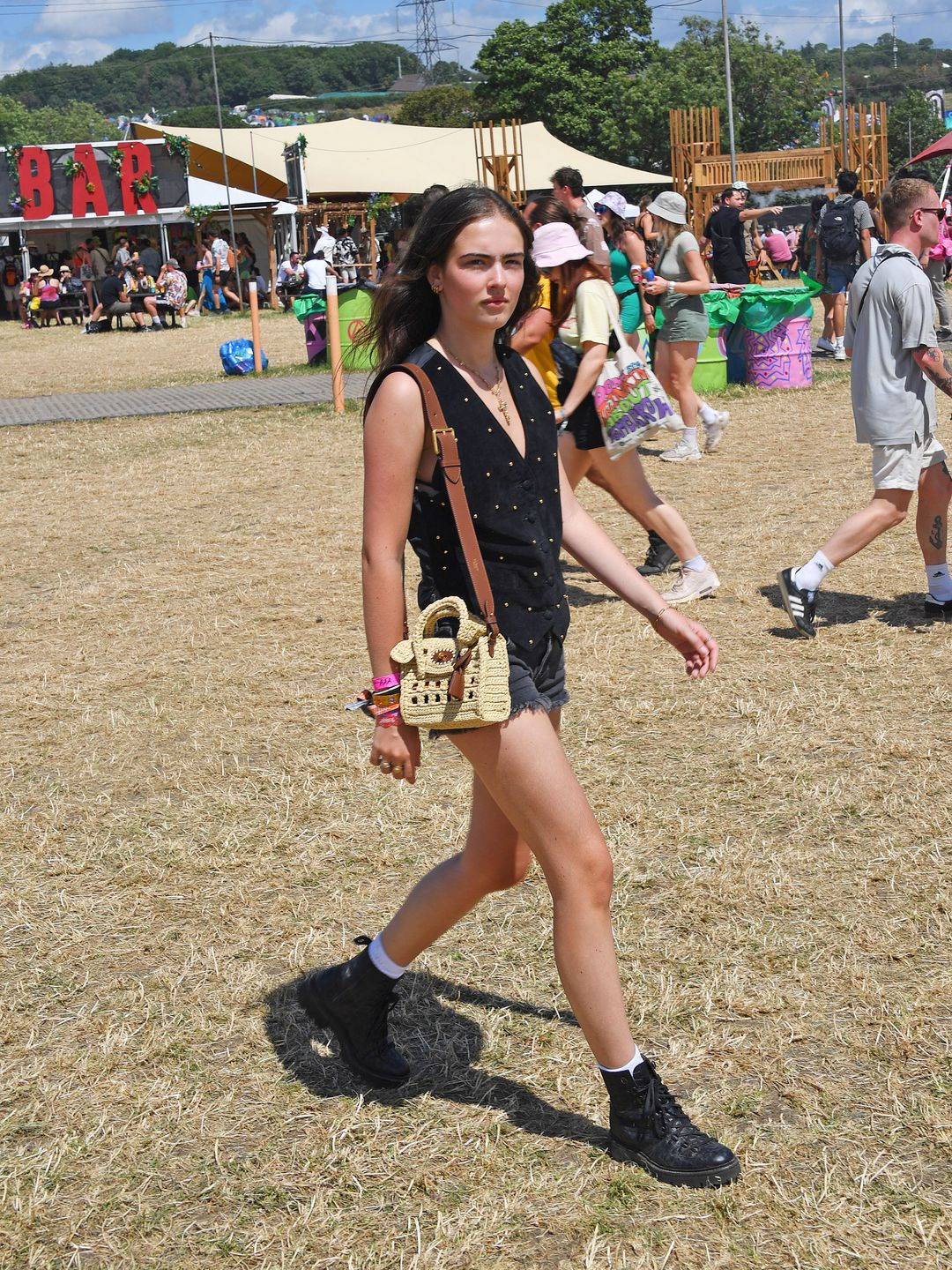 Stella Jones attended day four of Glastonbury wearing black denim micro shorts and a rattan Mulberry bag. 