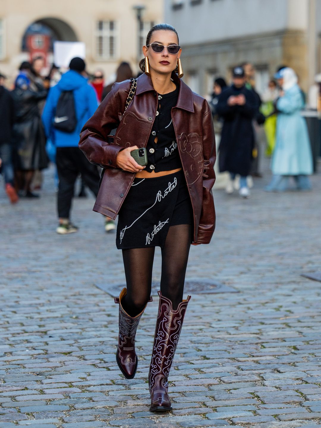 Vera van Erp rocks cowboy boots with a burgundy boxy jacket 