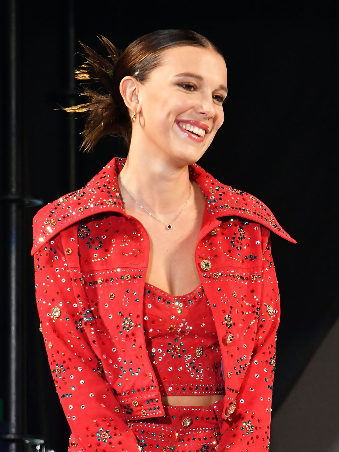millie bobby brown smiling on stage
