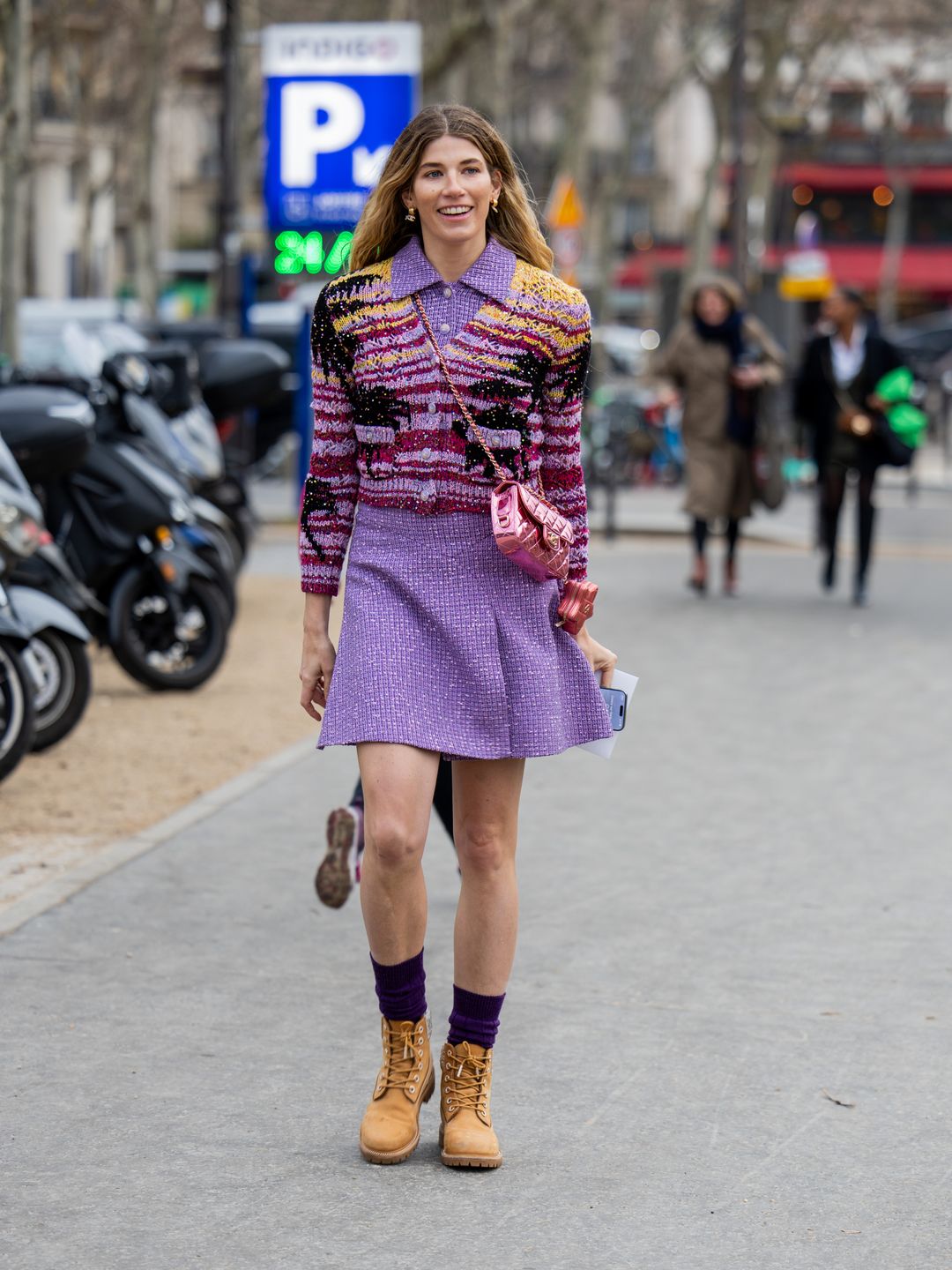 Veronika Heilbrunner wears pink skirt, blouse, cardigan, metallic pink Chanel bag, boots outside Chanel during the Haute Couture Spring/Summer 2024 