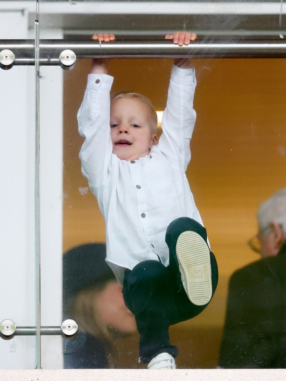 young boy in stands at races