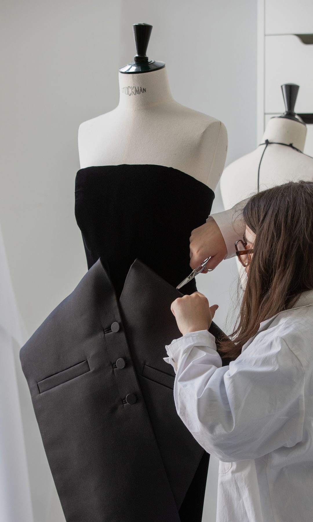 black gown being made by dior tailor