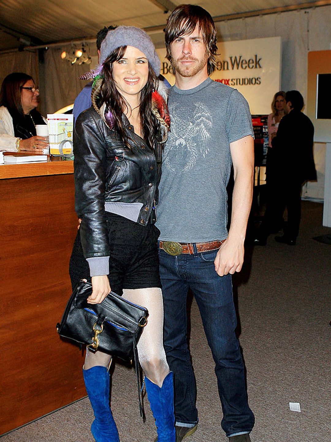 Juliette Lewis and Steve Berra. She is wearing a leather jacket and shorts, while he is dressed in a grey T-shirt and jeans