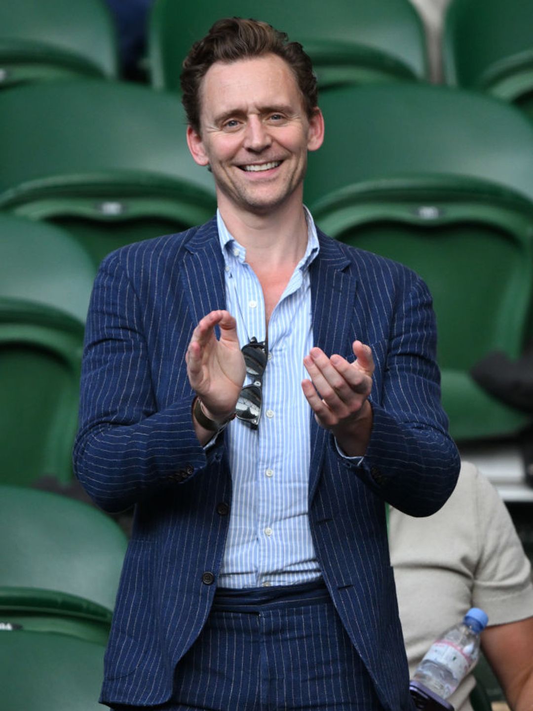 Tom Hiddleston claps at Wimbledon. 